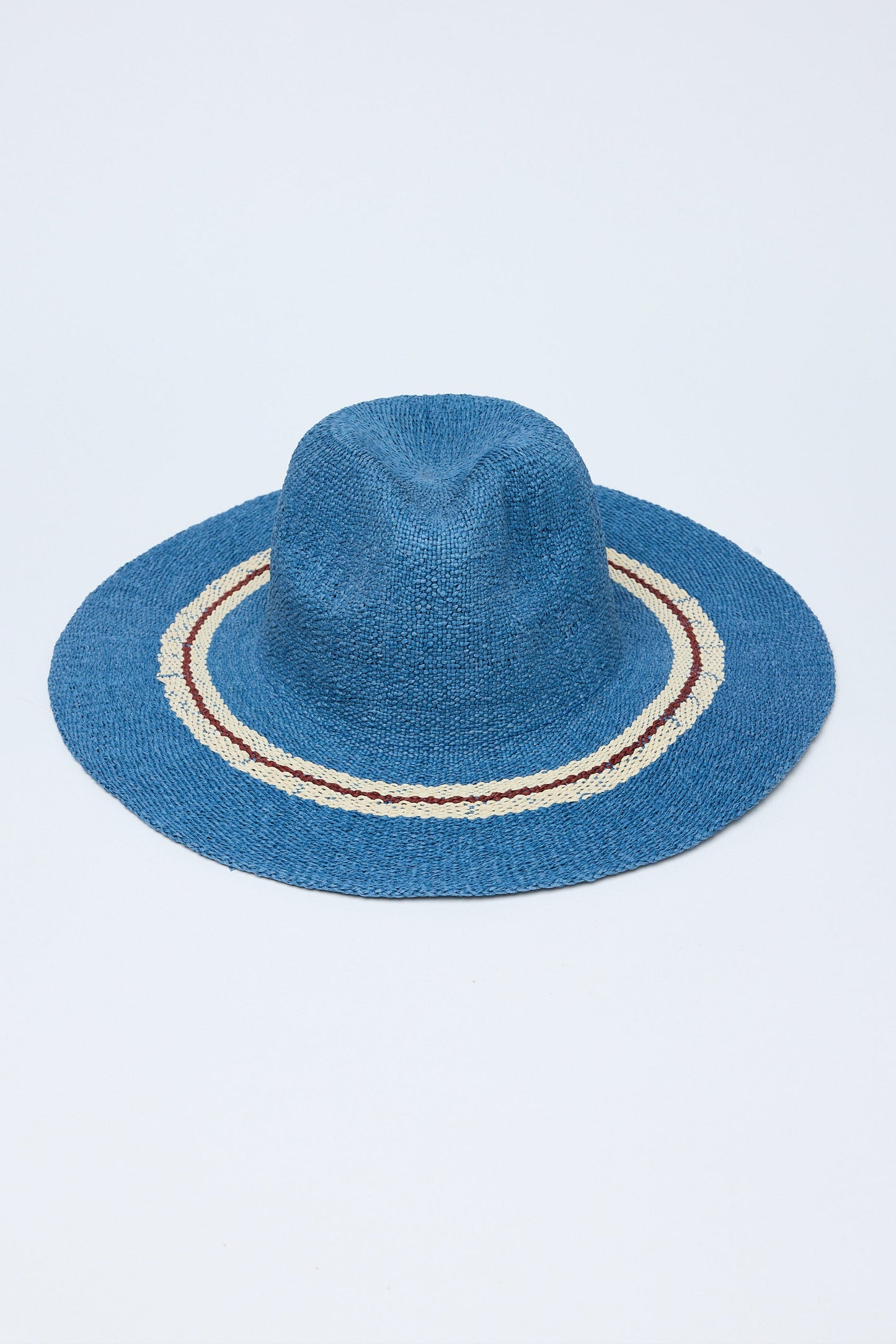 Blue straw hat with a decorative band on a white background