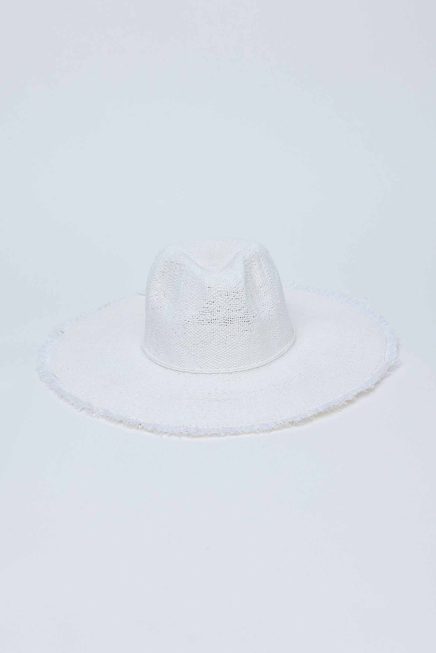 White straw hat on a light gray background