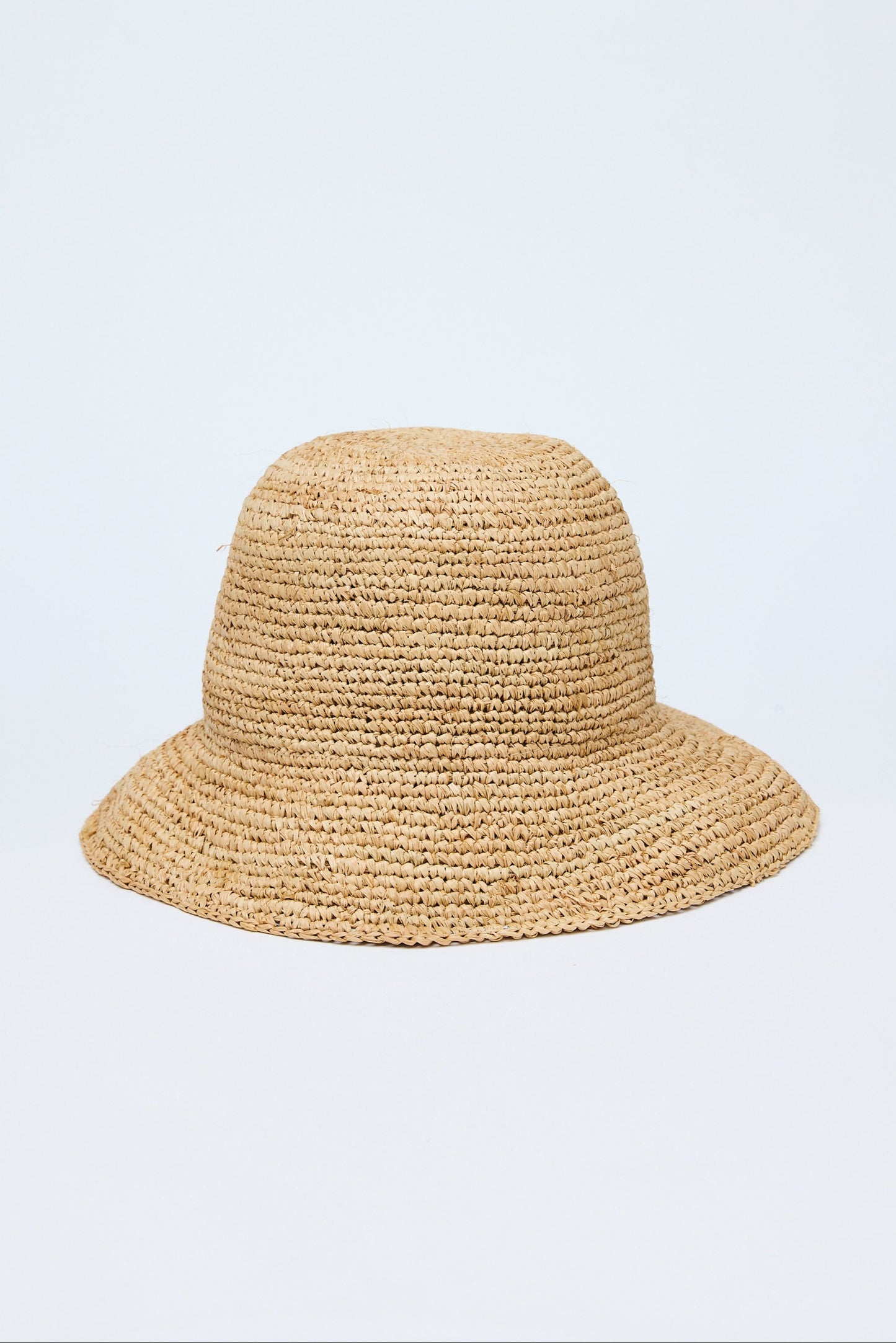 Beige straw hat on a light purple background