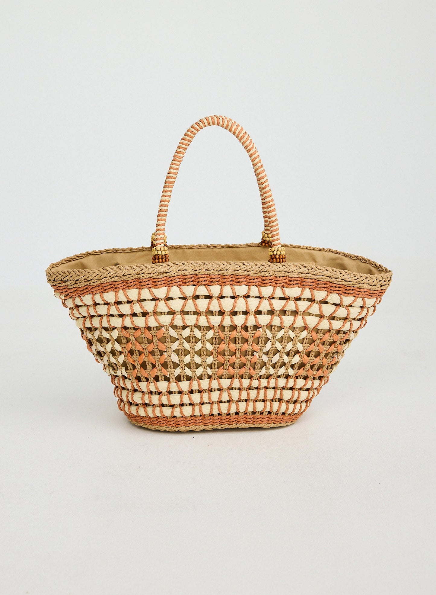 Woven basket with diamond pattern on a light gray background