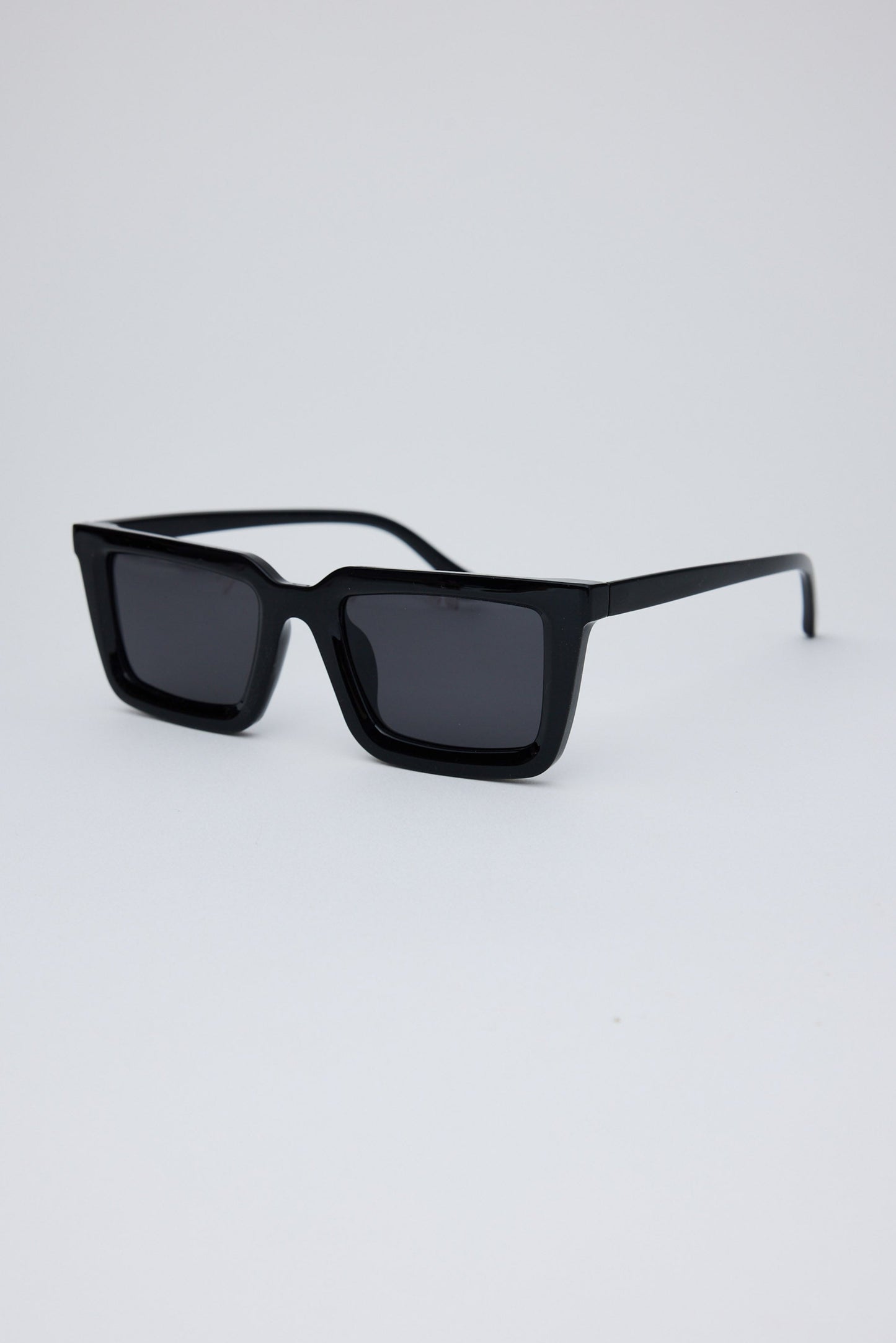 Black sunglasses on a light gray background