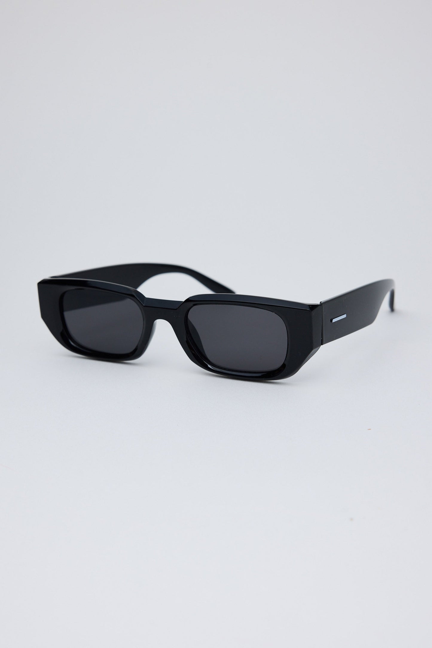 Black sunglasses on a light gray background