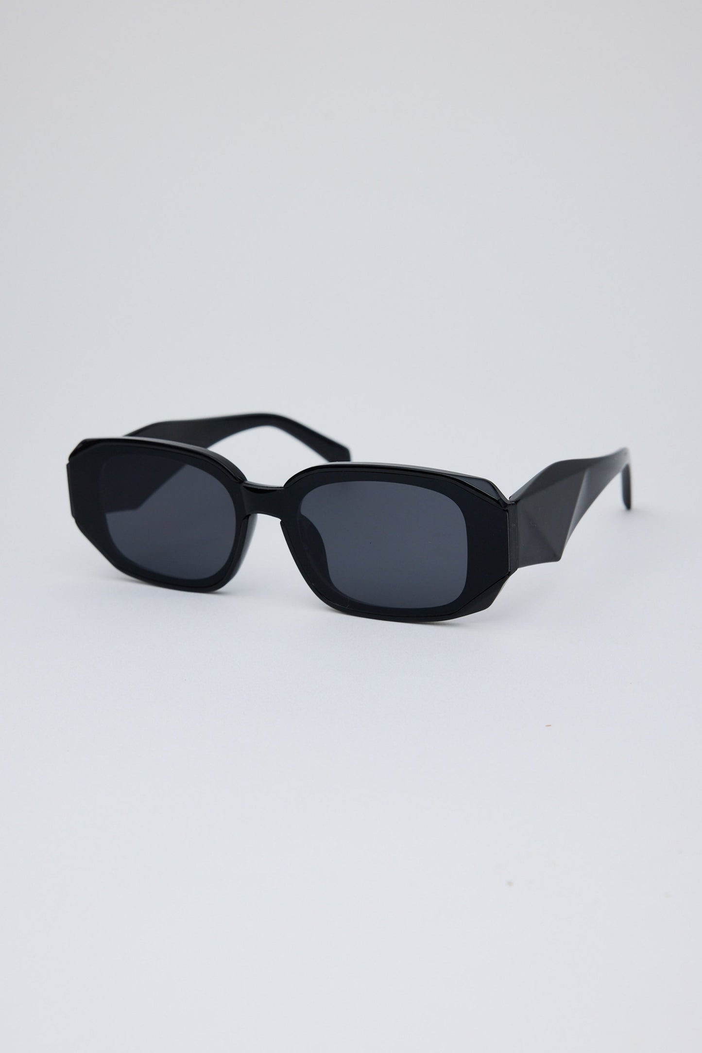 Black sunglasses on a light gray background
