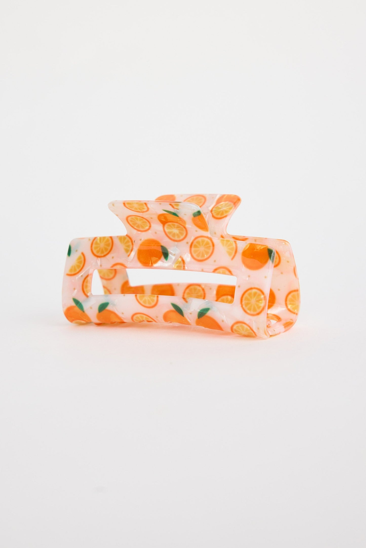 Hair clip with orange pattern on a white background