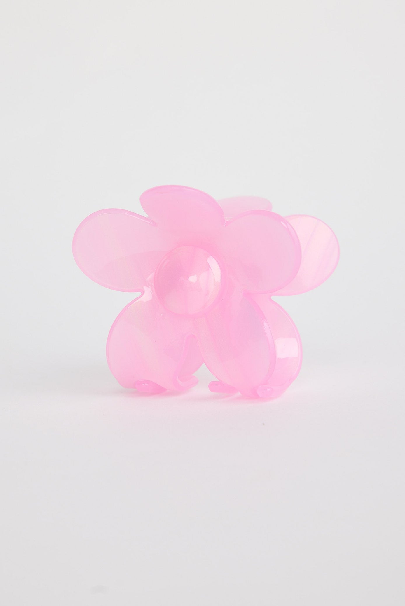 Pink flower shaped hair claw on a light gray background