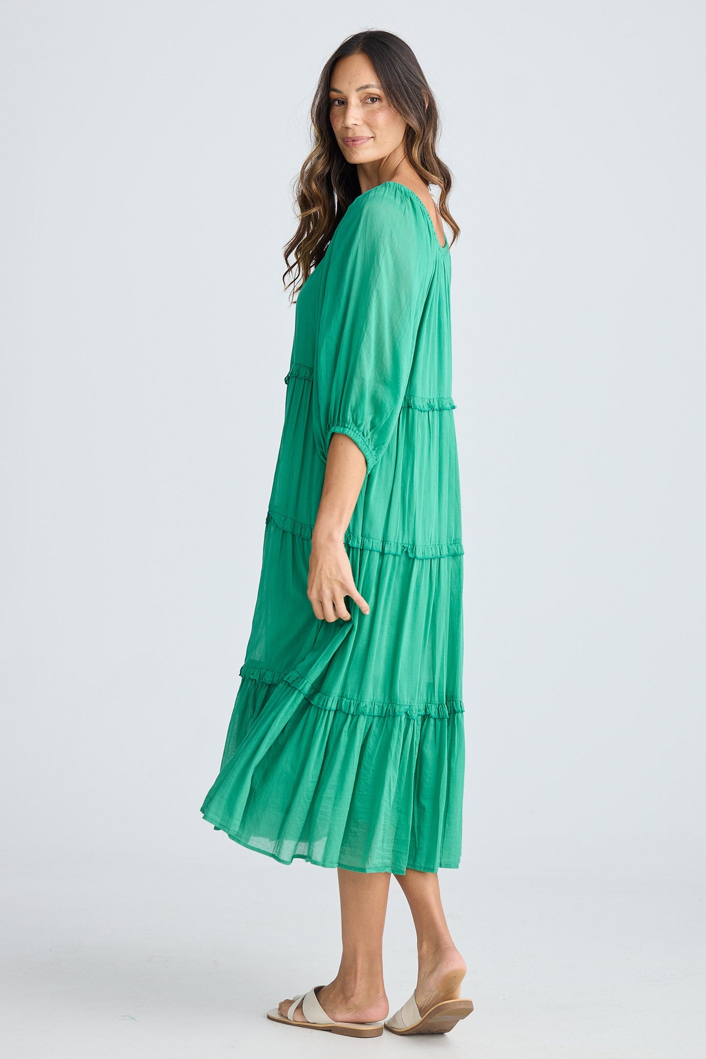 Woman wearing a green dress on a white background