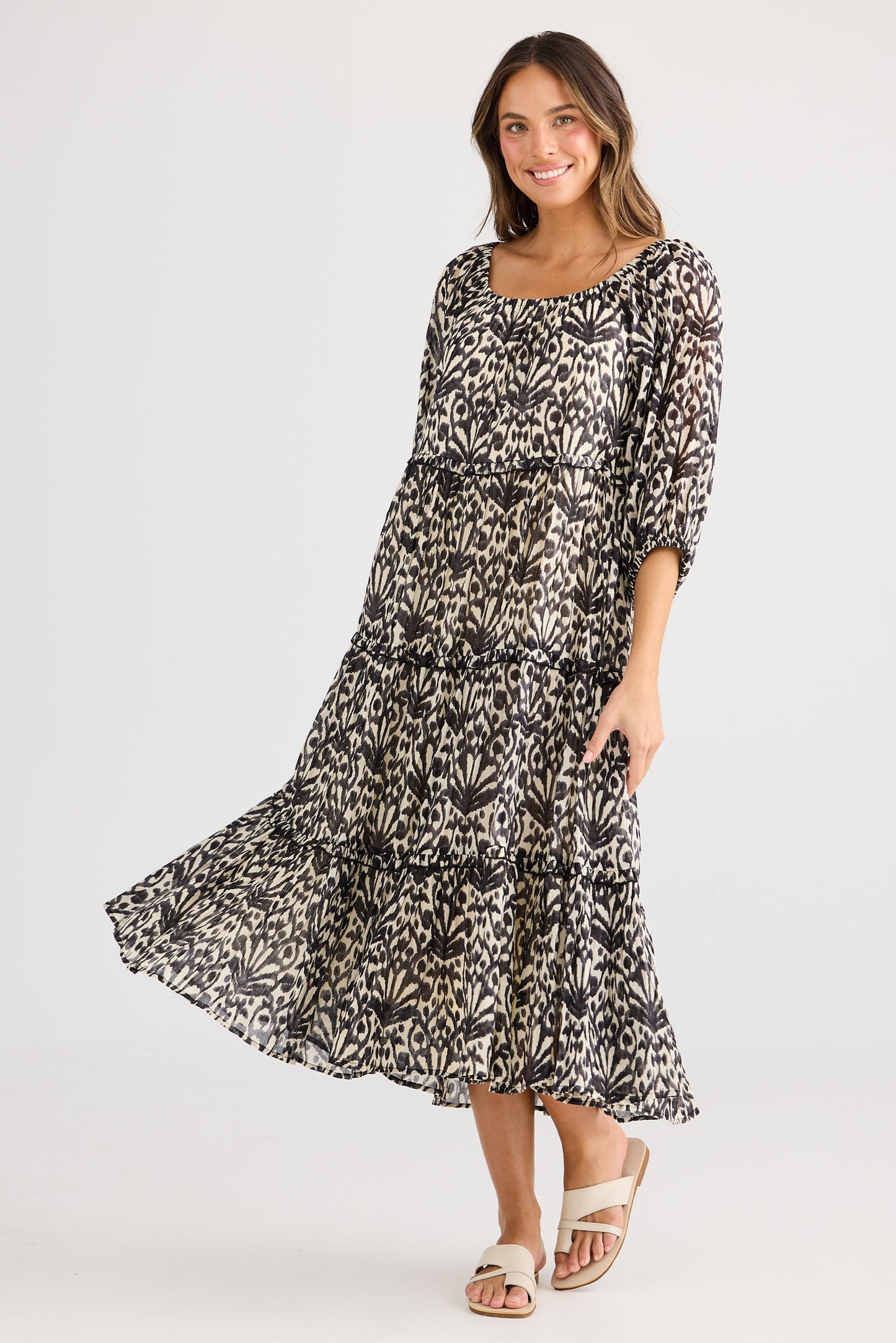 Woman wearing a patterned dress on a white background