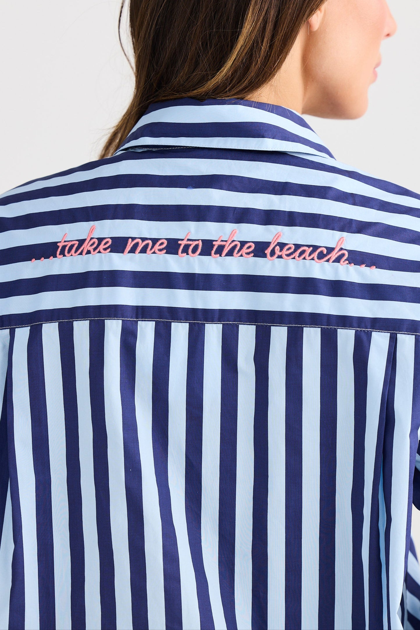 Navy and white striped shirt with 'take me to the beach' text on a plain background