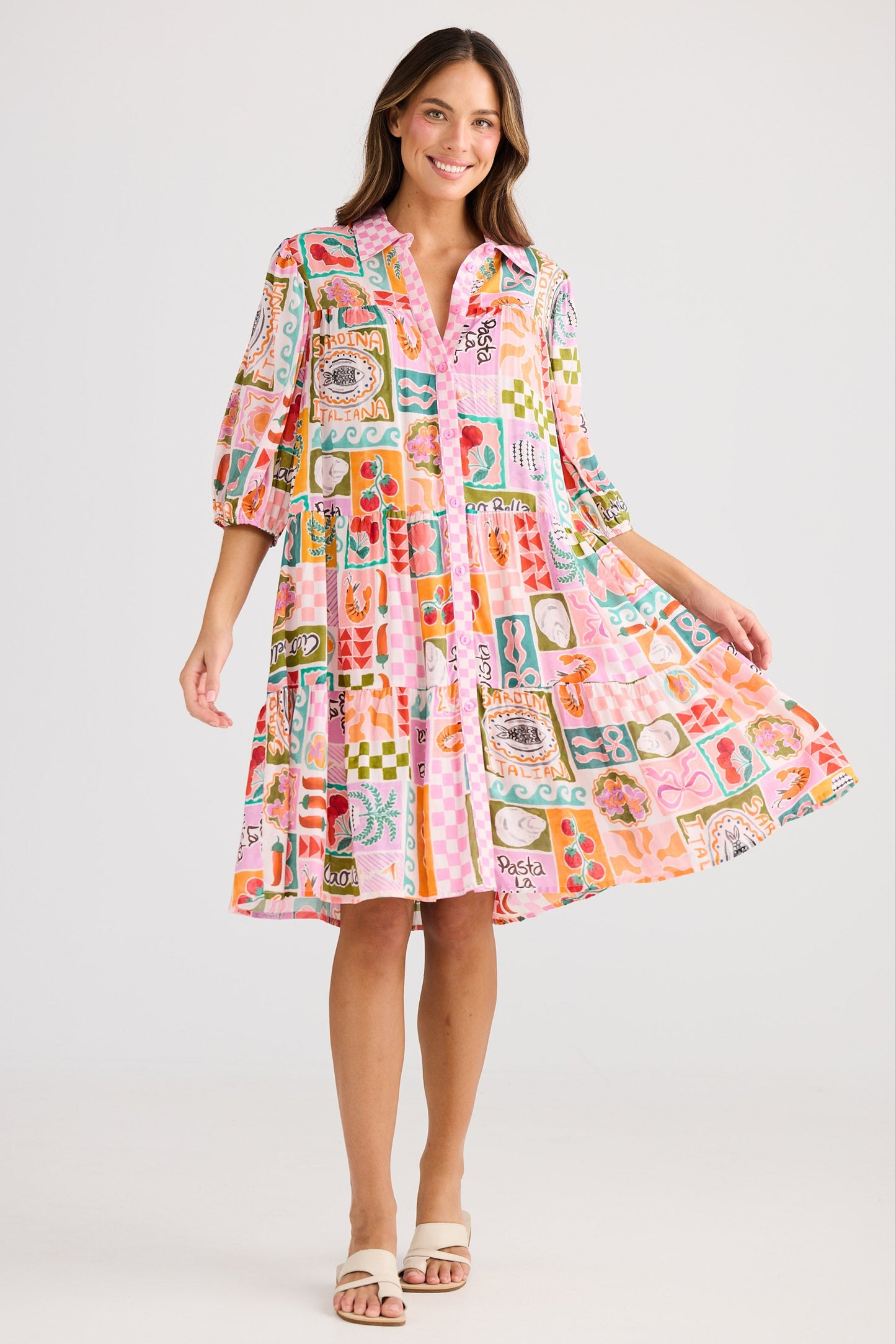 Woman wearing a colorful patterned dress on a white background
