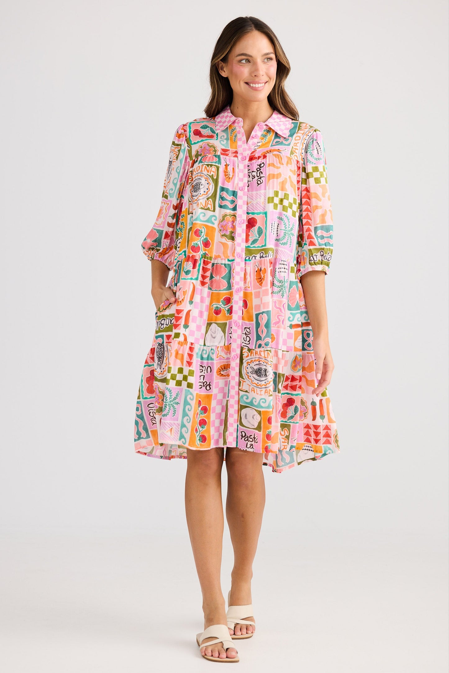 Woman wearing a colorful patterned dress on a white background