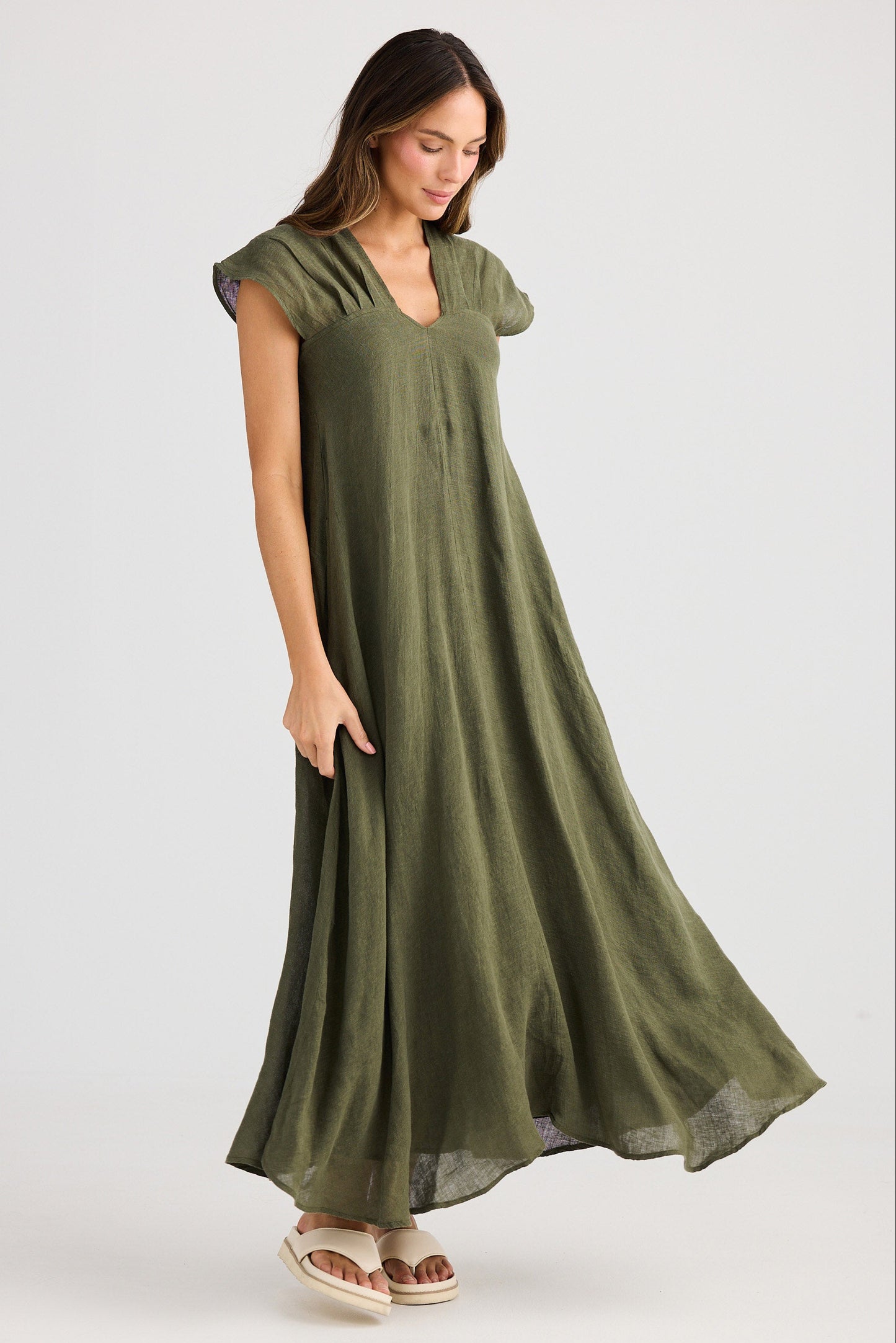 Woman wearing a green dress on a white background