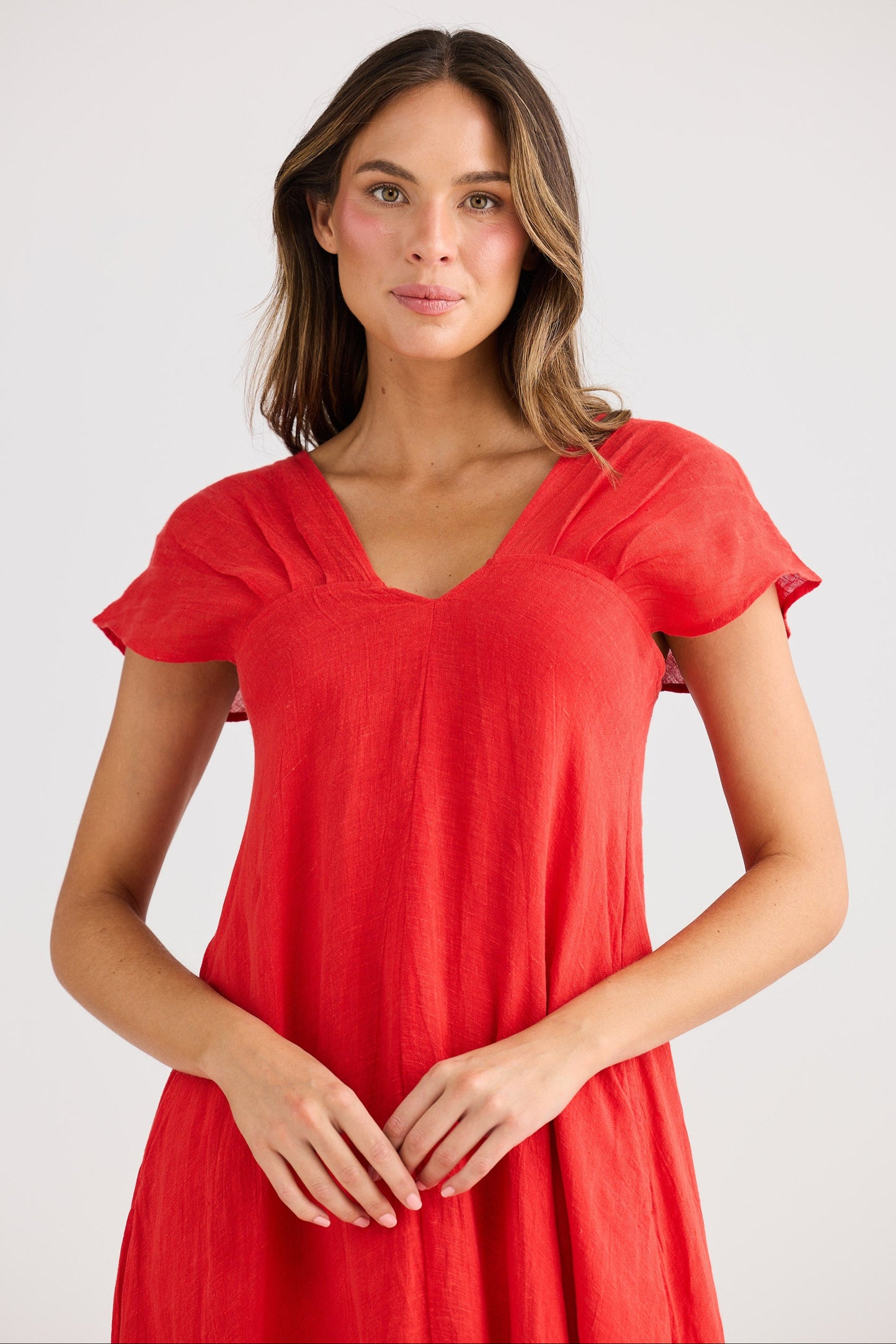Woman wearing a red dress against a white background