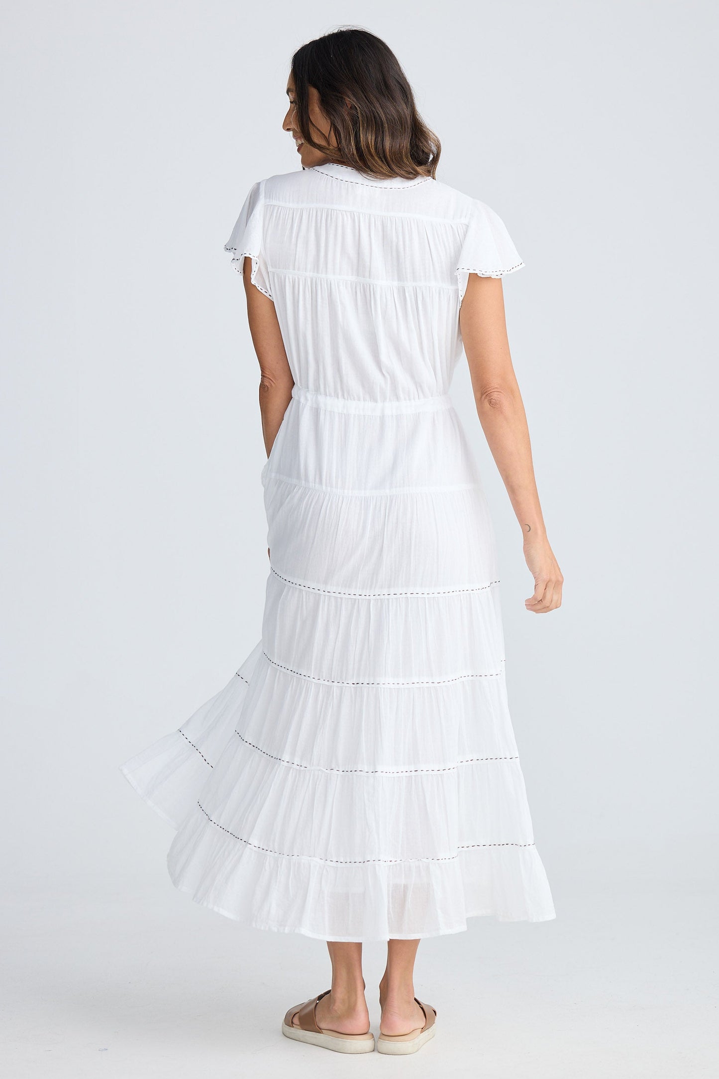 Woman wearing a white dress on a white background