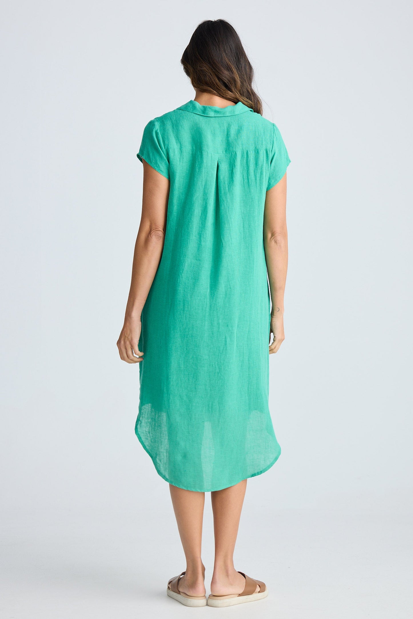 Woman wearing a green dress on a white background