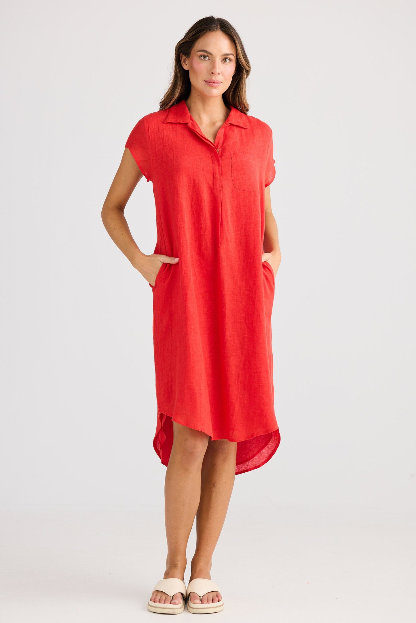 Woman wearing a red short sleeve dress on a white background