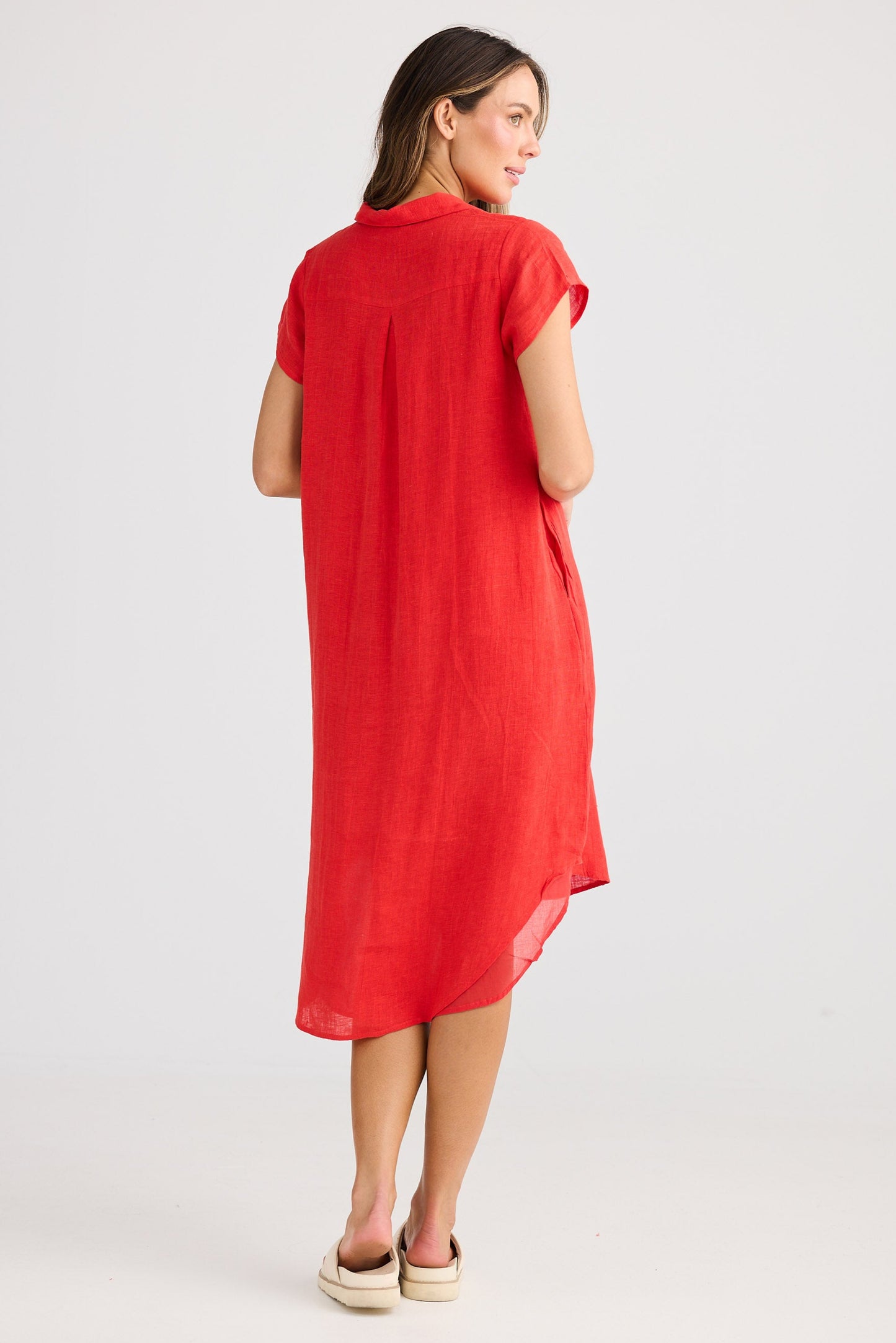 Woman wearing a red dress on a white background
