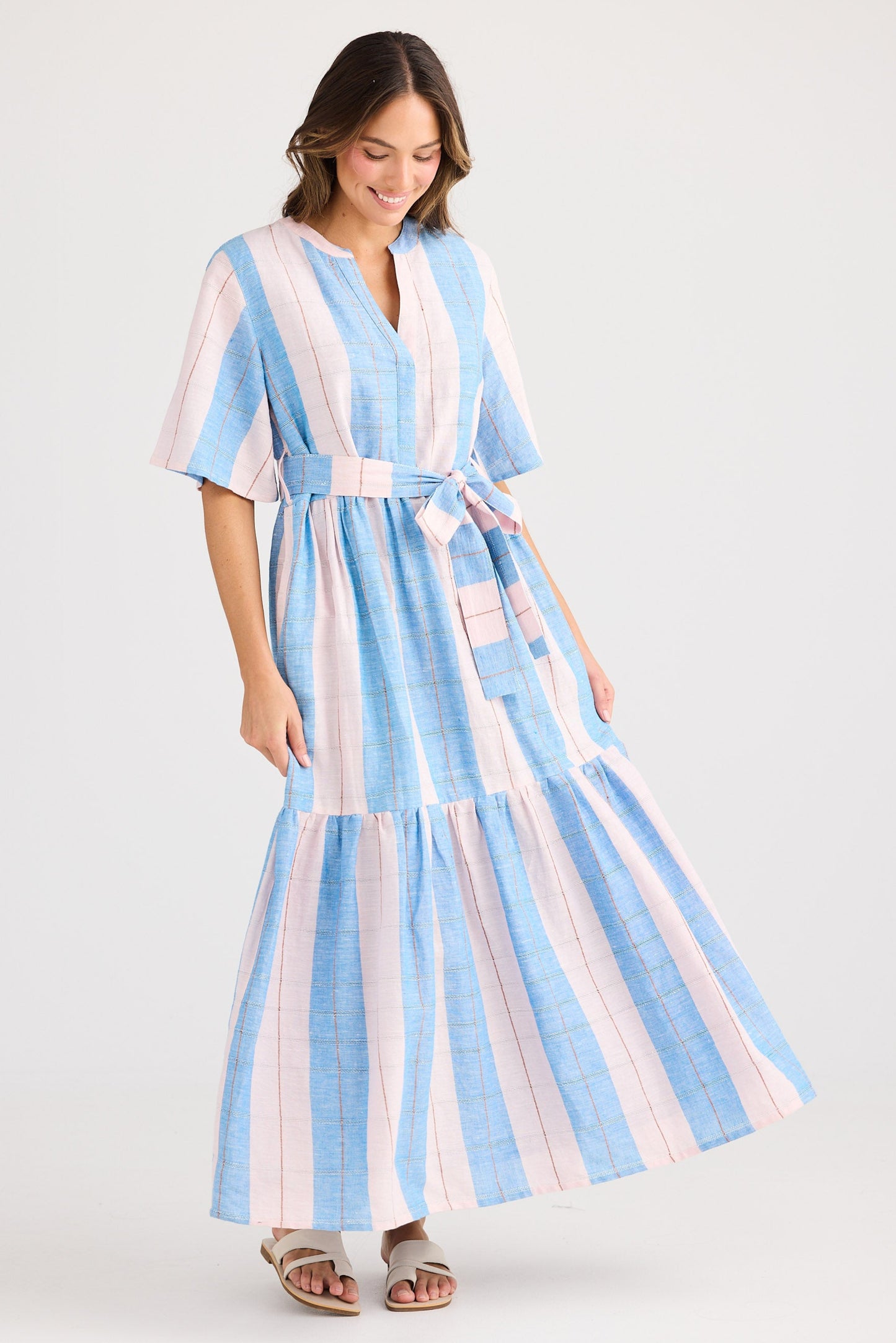 Woman wearing a striped dress with a white background