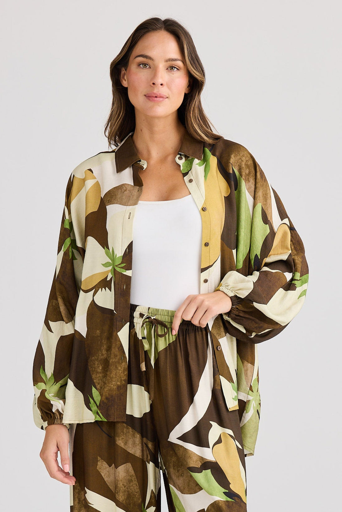 Woman wearing a patterned kimono-style outfit on a white background