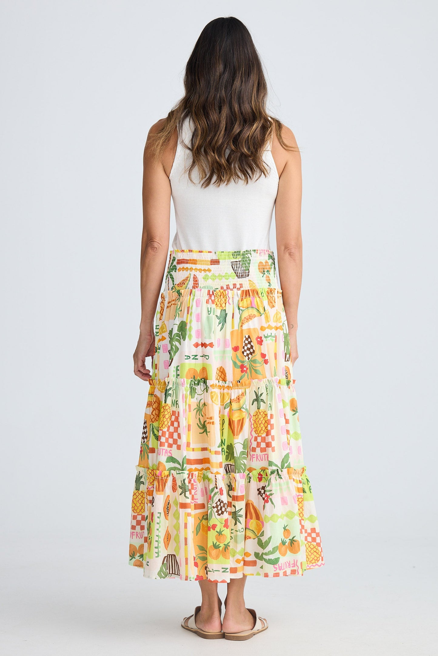 Woman wearing a colorful patterned skirt on a white background