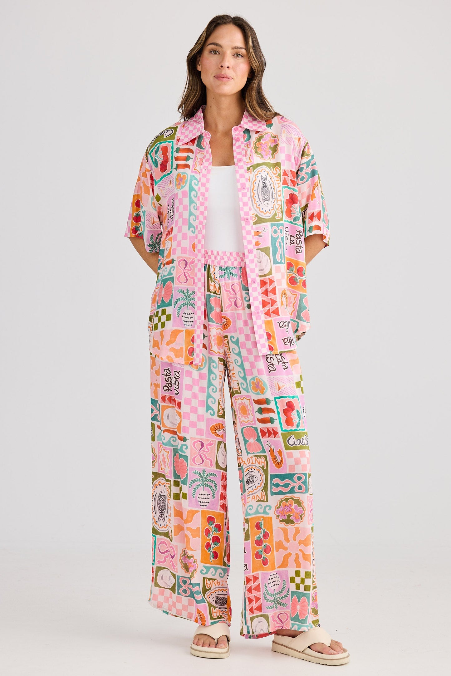 Woman wearing a colorful patterned outfit on a white background