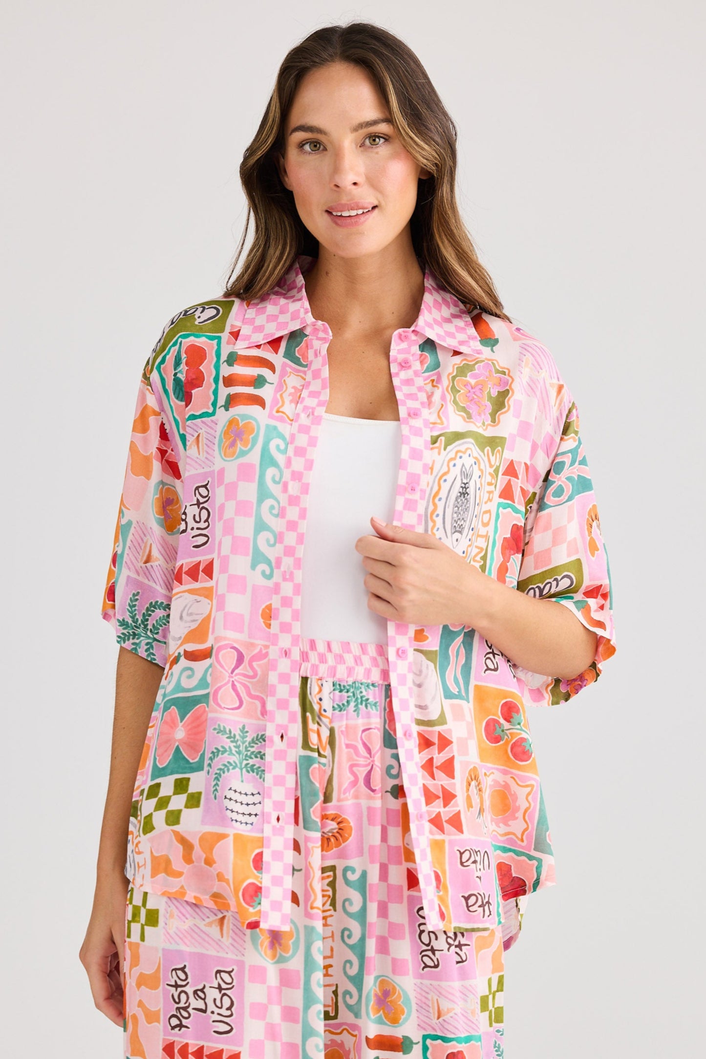 Woman wearing a colorful patterned kimono-style robe on a white background