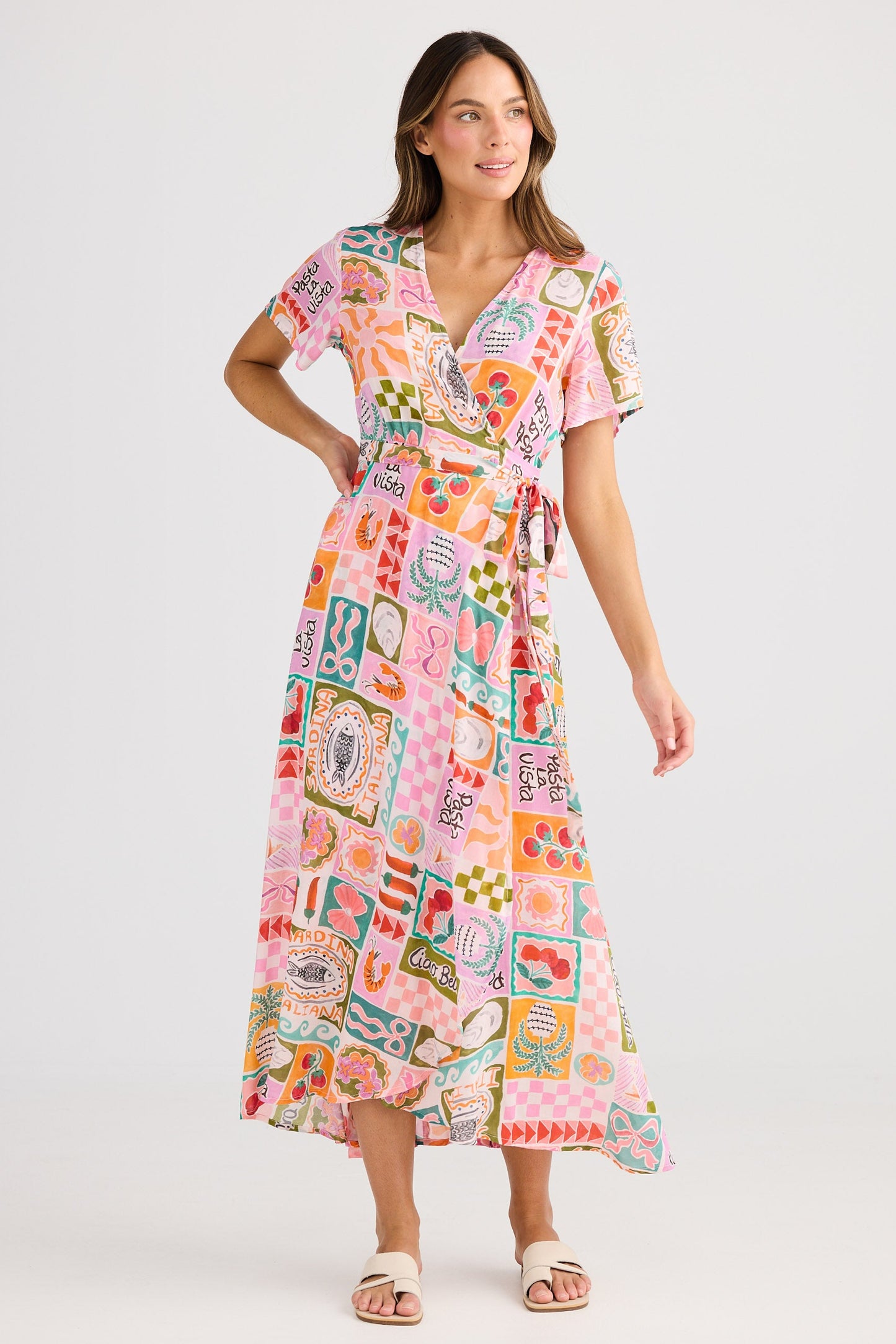 Woman wearing a colorful patterned dress on a white background