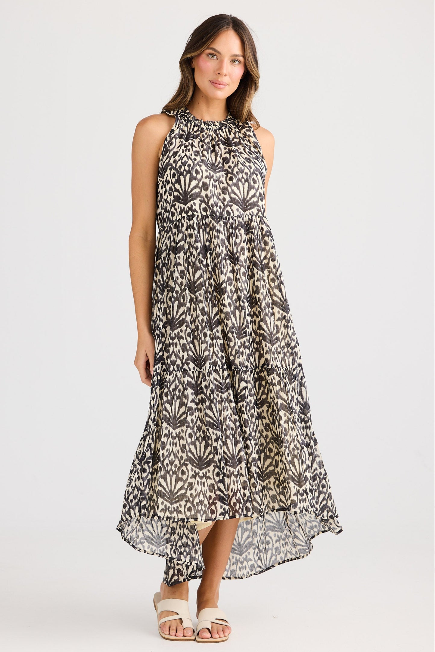 Woman wearing a patterned dress on a white background