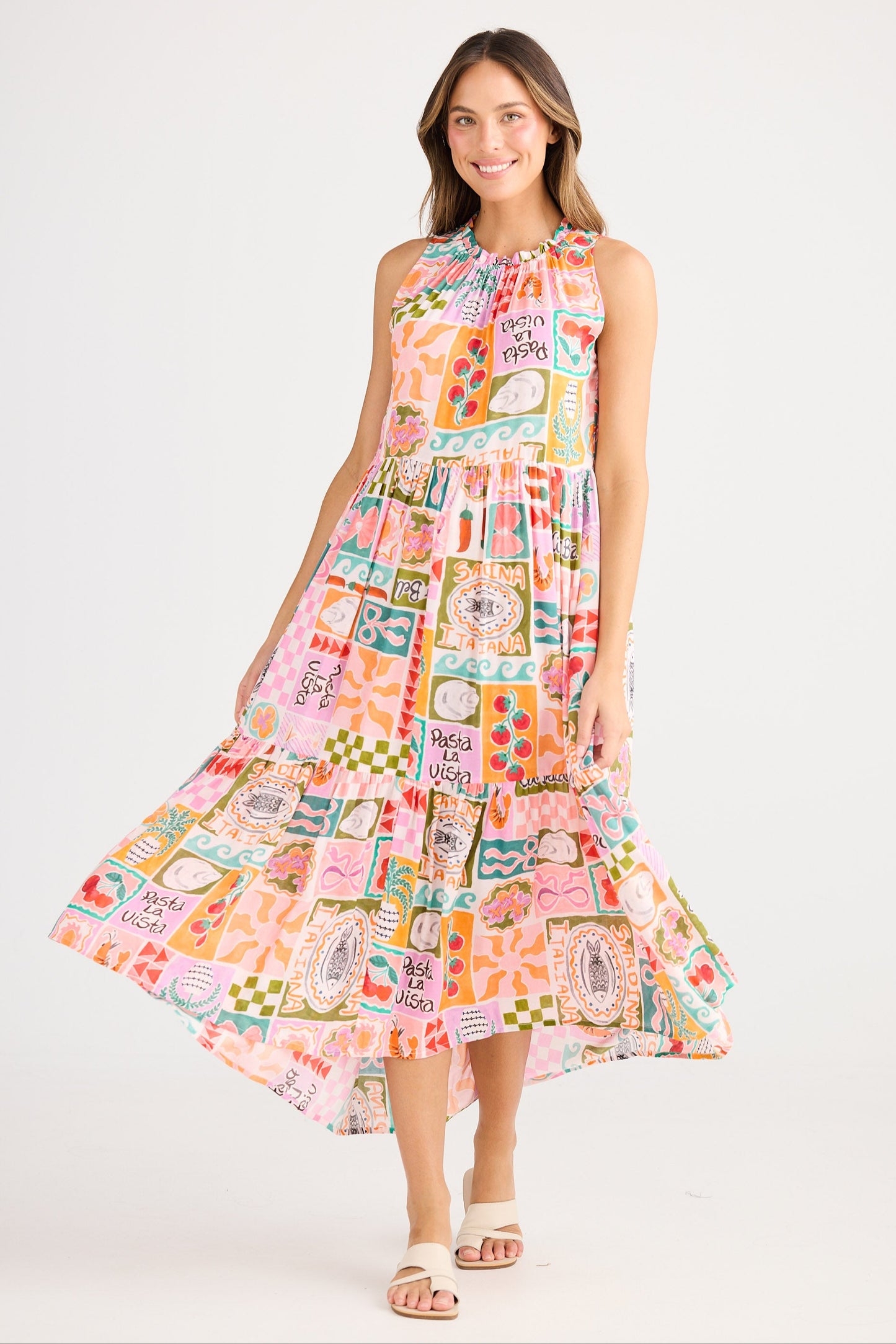 Woman wearing a colorful patterned dress on a white background