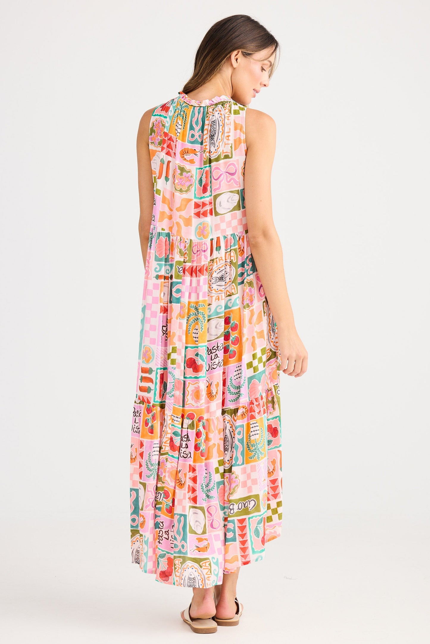 Woman wearing a colorful sleeveless dress on a white background