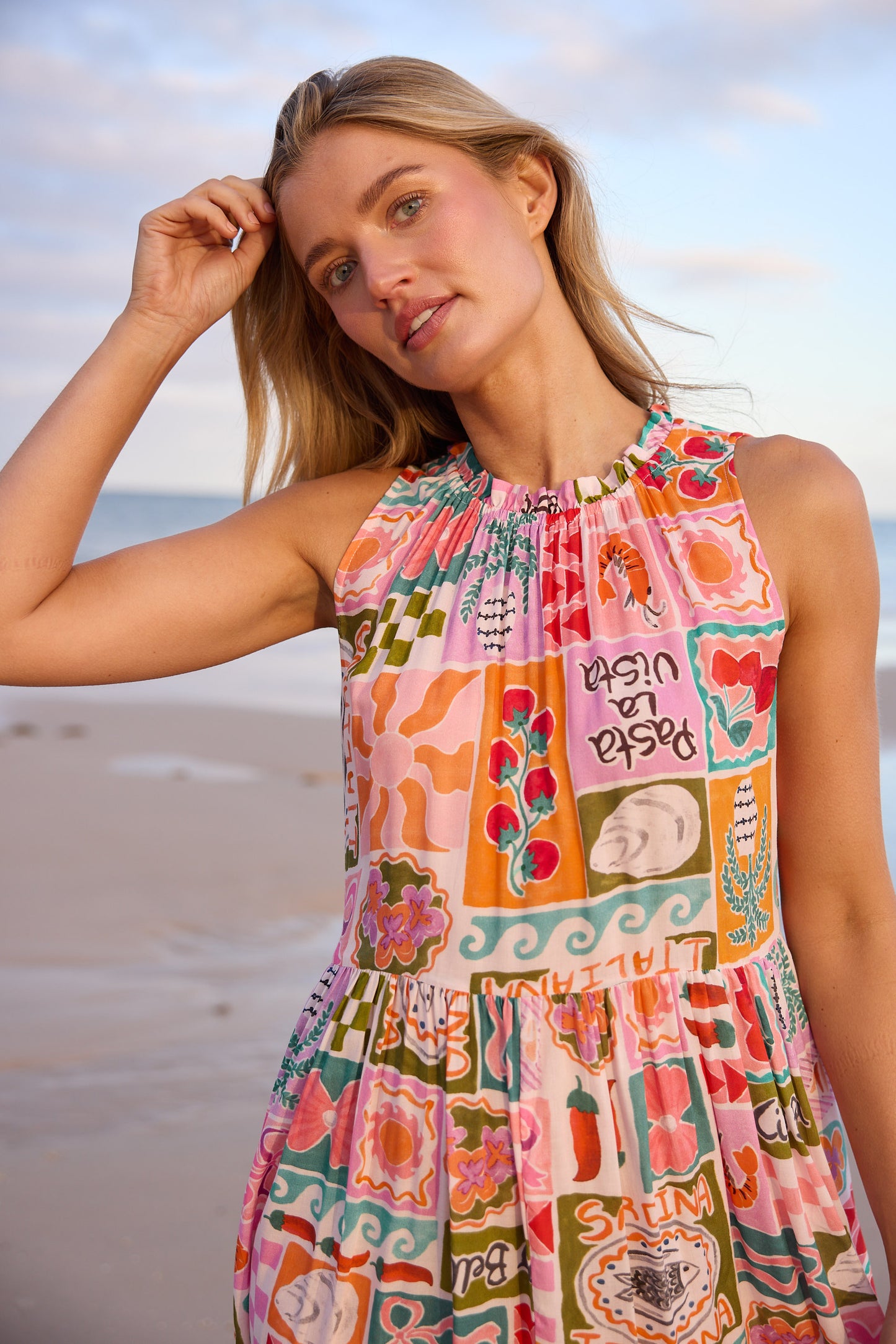Woman wearing a colorful patterned dress on a beach