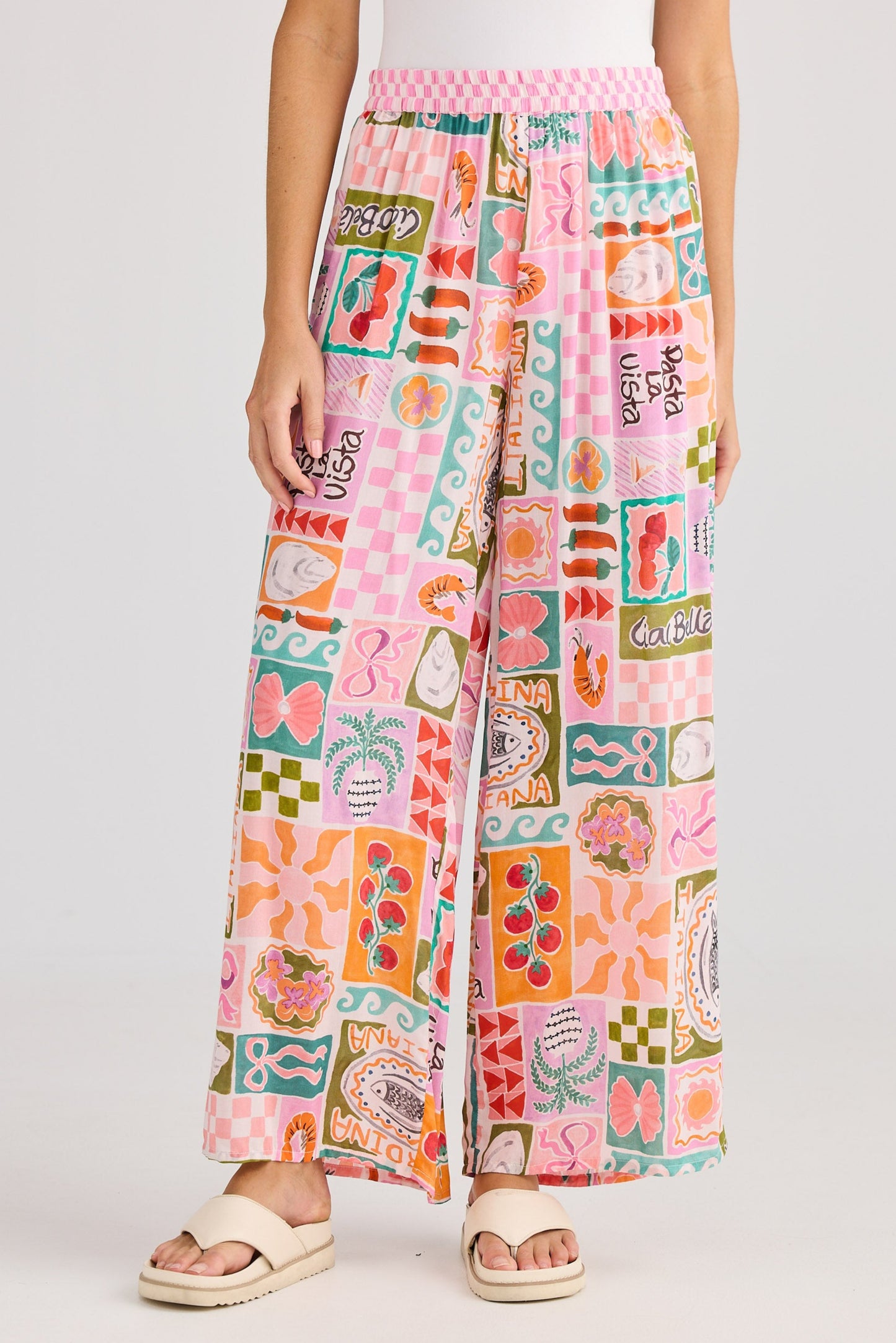 Person wearing colorful patterned pants on a plain background