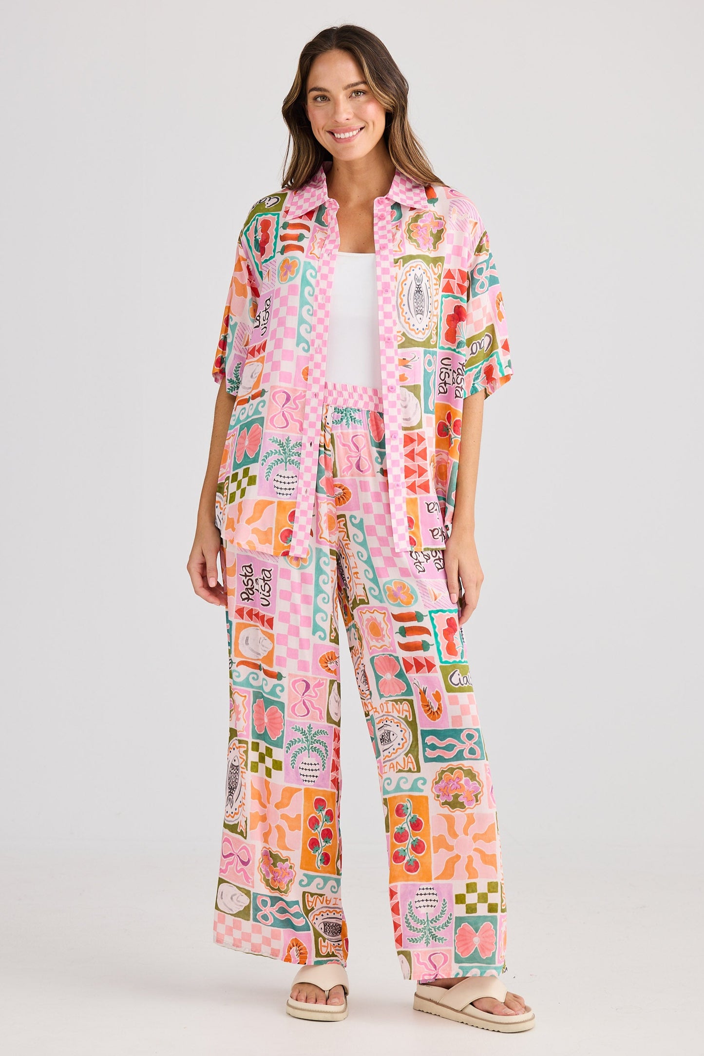 Woman wearing a colorful patterned outfit on a white background