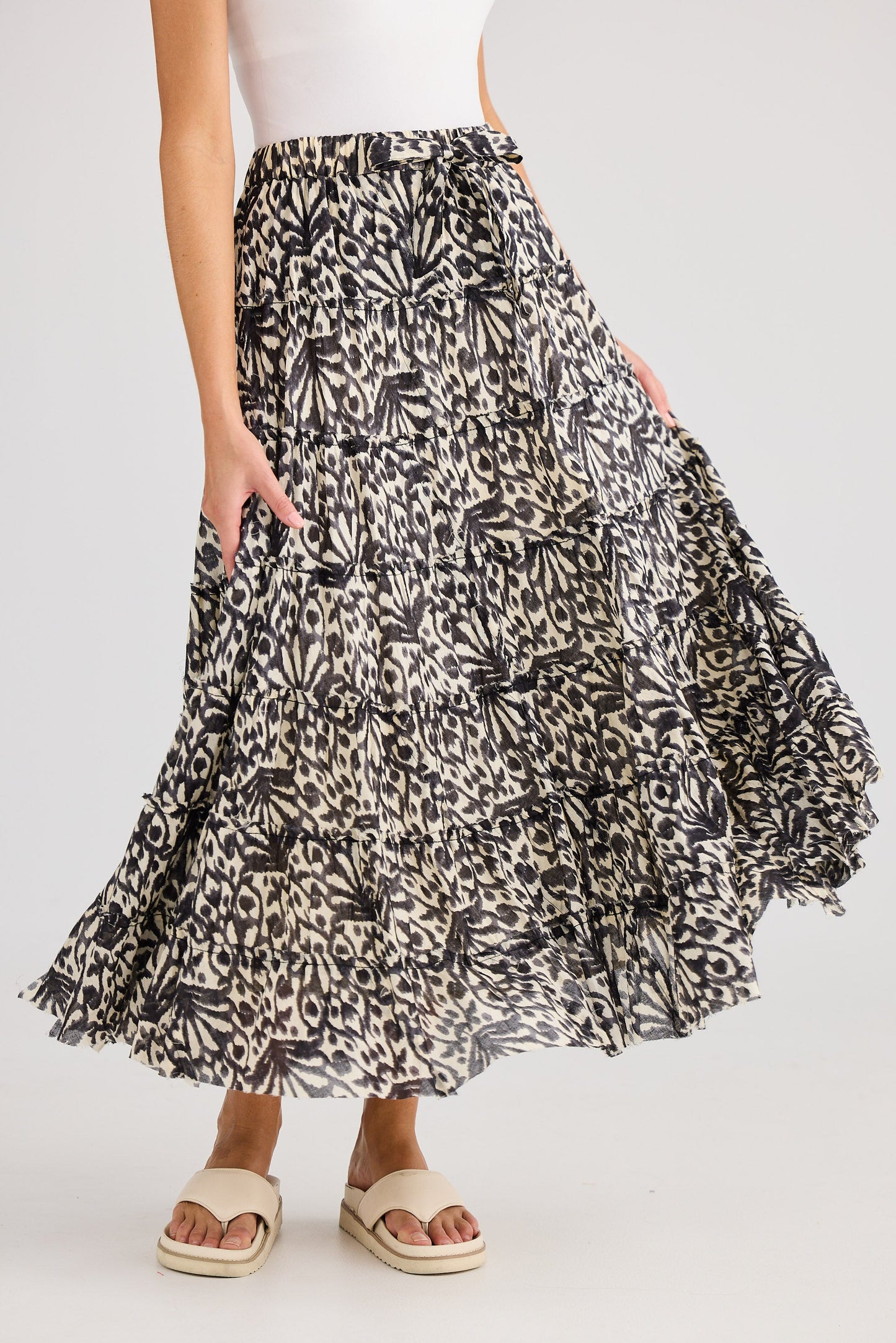 Woman wearing a patterned skirt on a white background