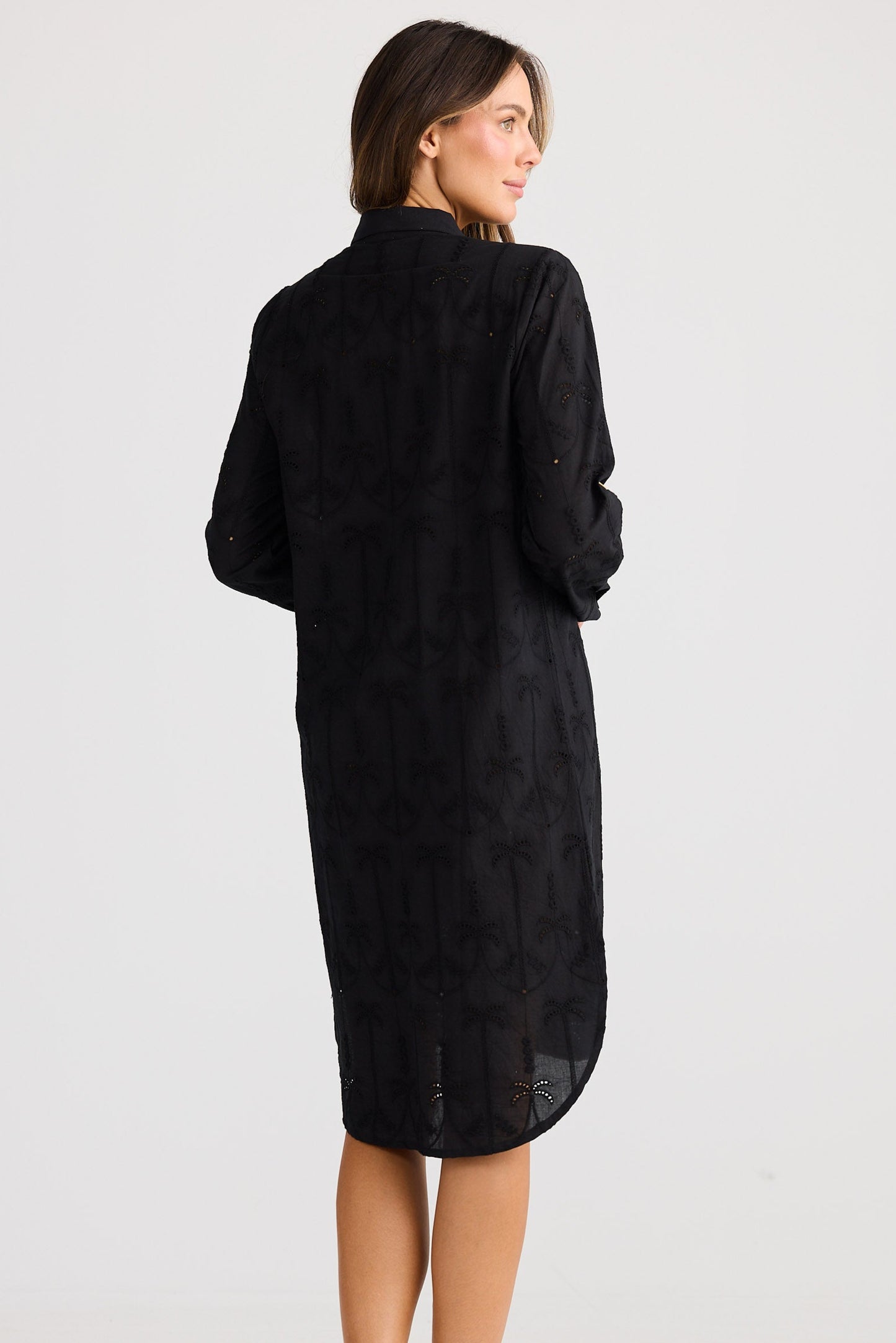 Woman wearing a black dress against a white background