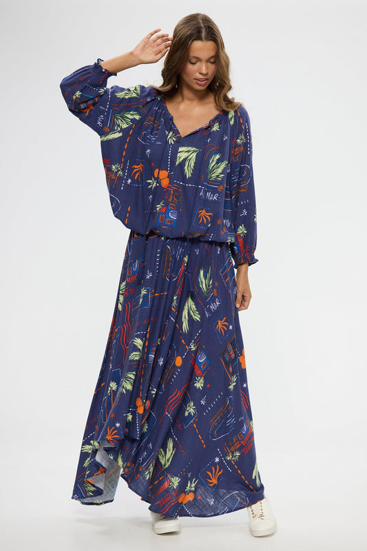 Woman wearing a blue floral top and skirt on a white background