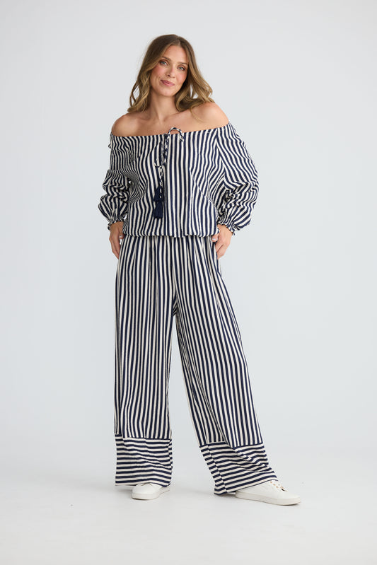Model wearing Seaside Top Navy and White Stripe with neck ties and shirred cuffs, front view on white background