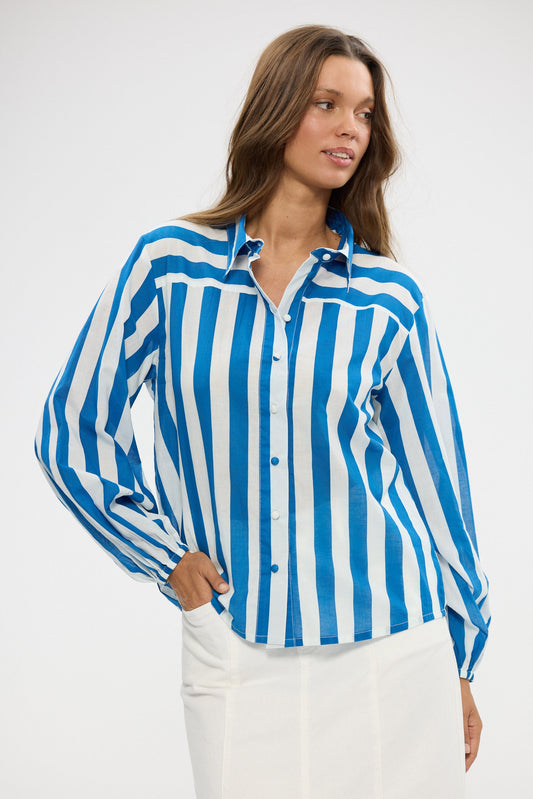 Woman wearing a blue and white striped shirt against a white background
