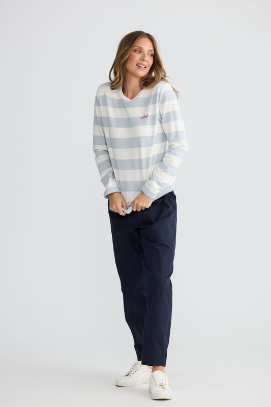 Model wearing Roam Tee Light Blue Stripe with long sleeves and striped finish, front view on white background