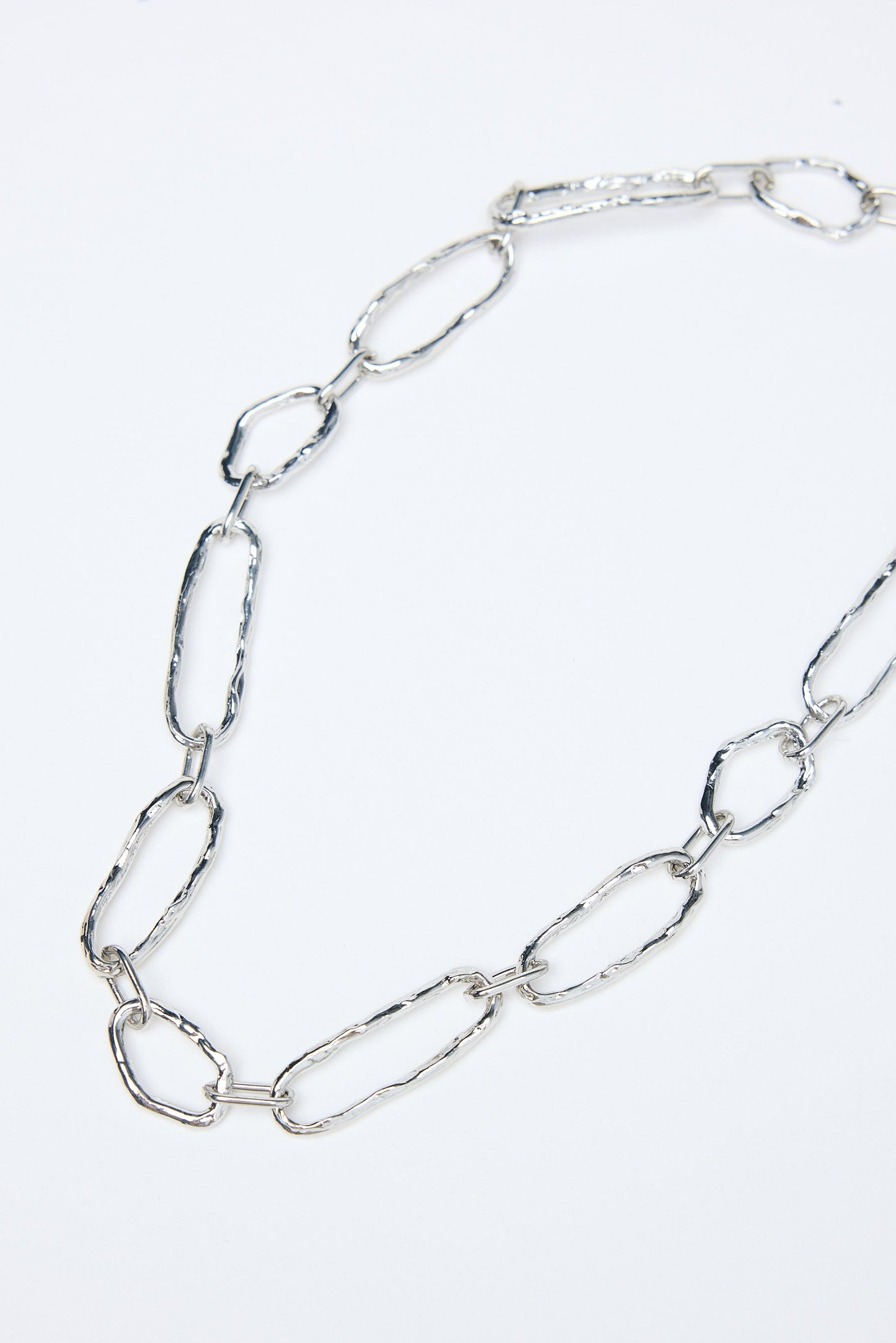 Silver chain necklace on a white background