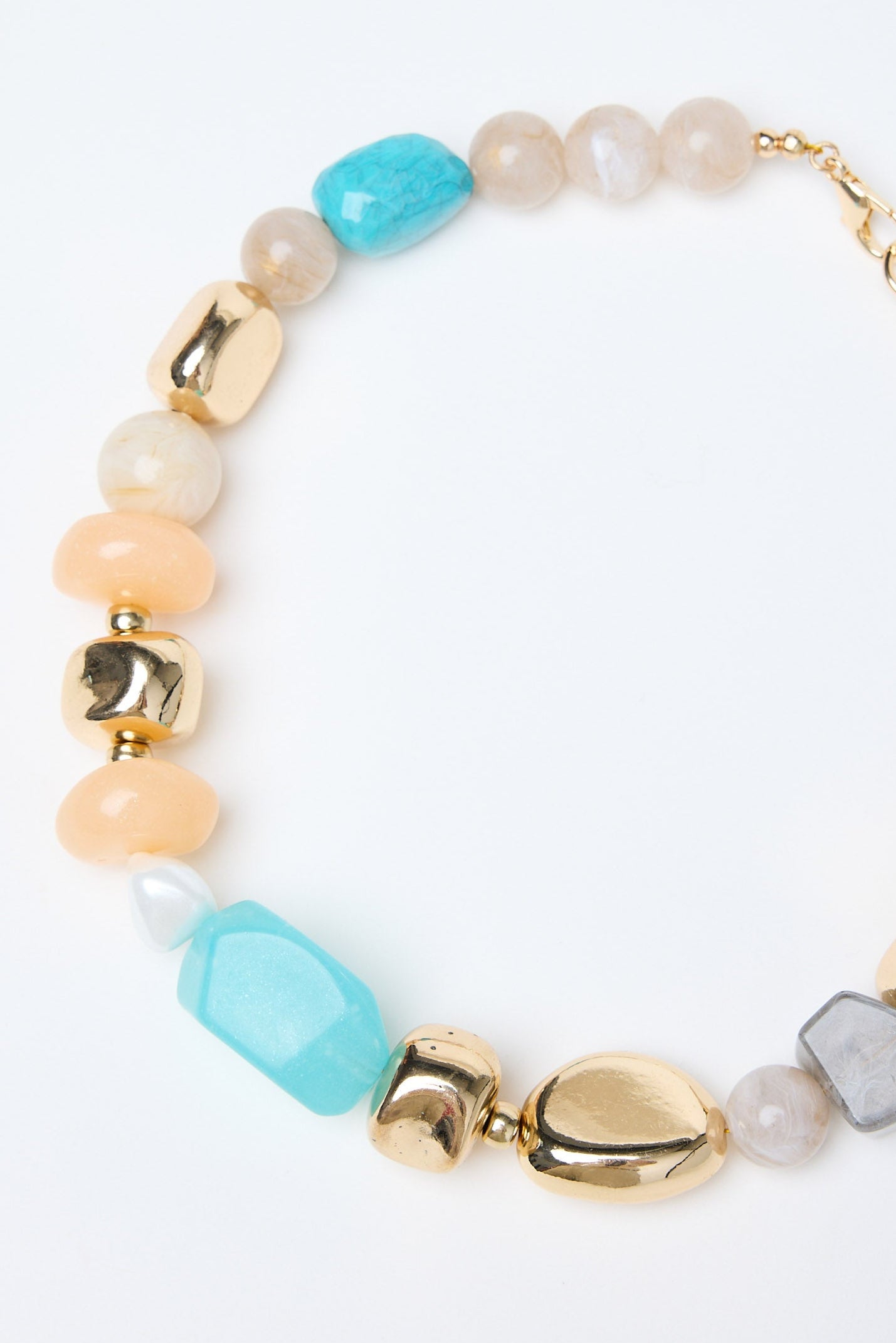 Multicolored beaded necklace with gold accents on a white background