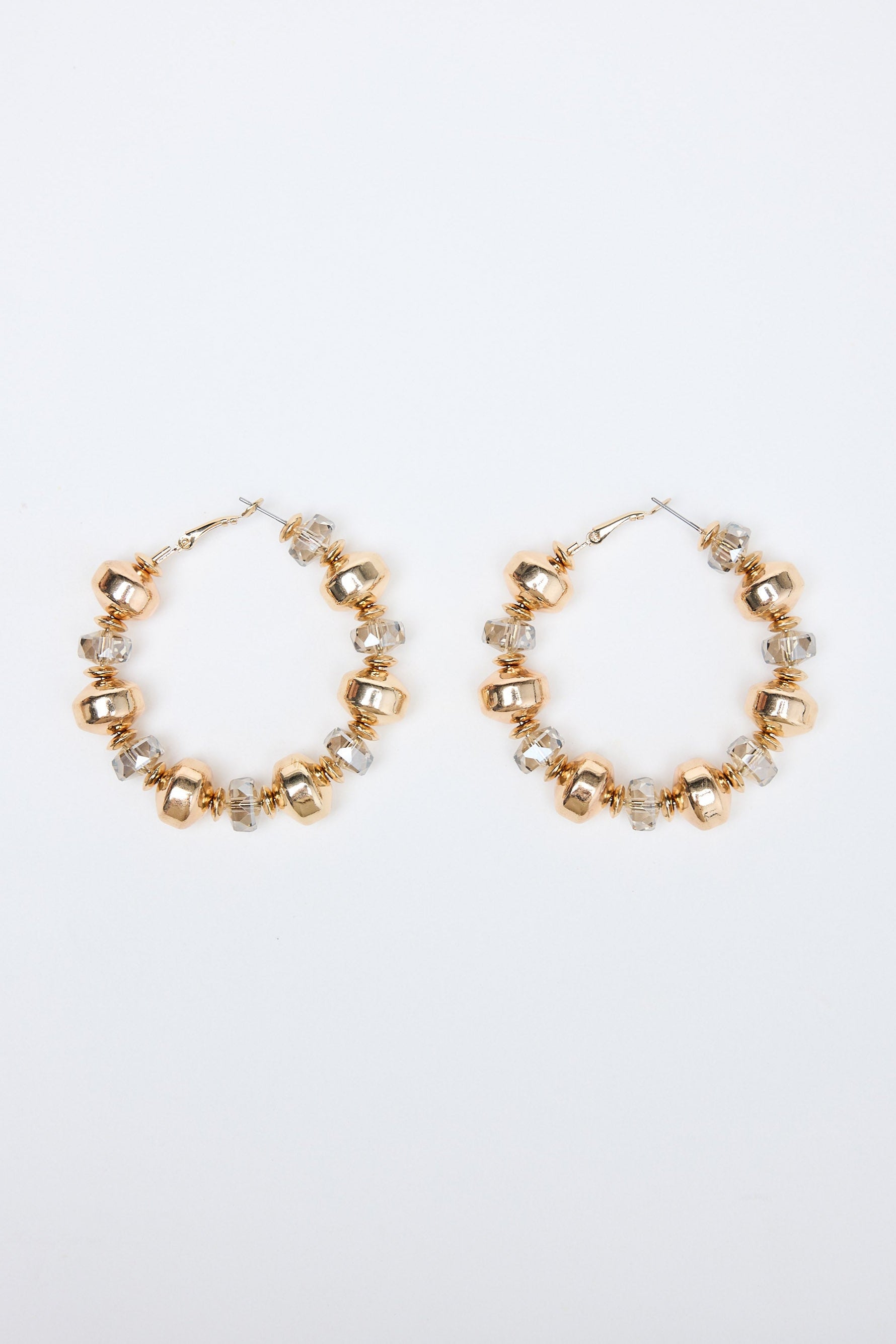 Gold hoop earrings with small beads on a white background