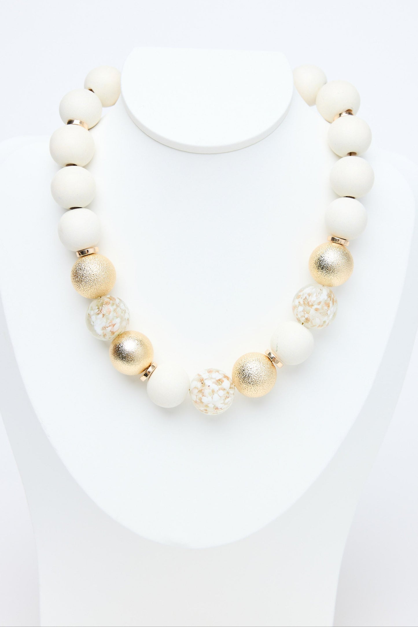 Necklace with white and gold beads on a white background