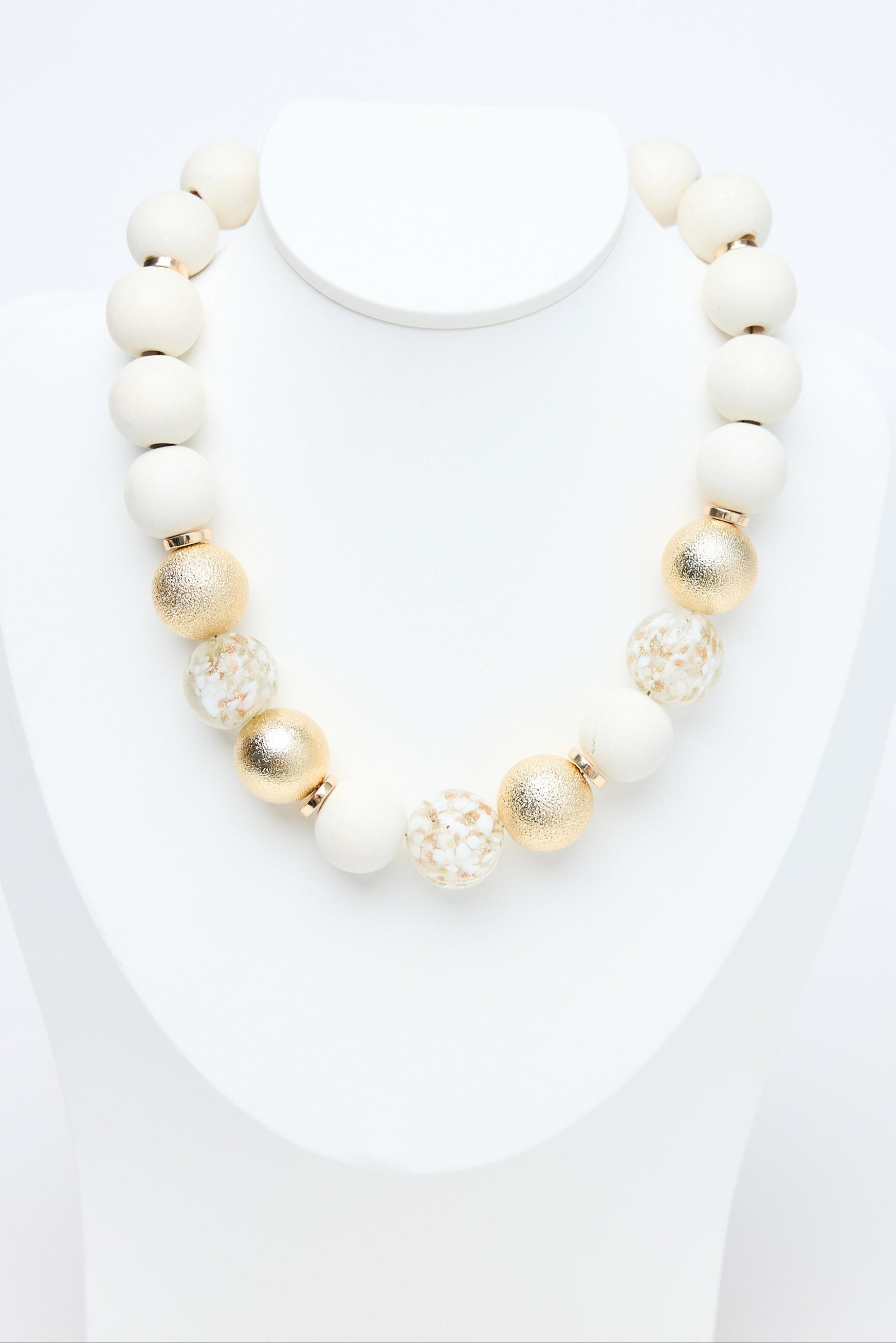 Necklace with white and gold beads on a white background