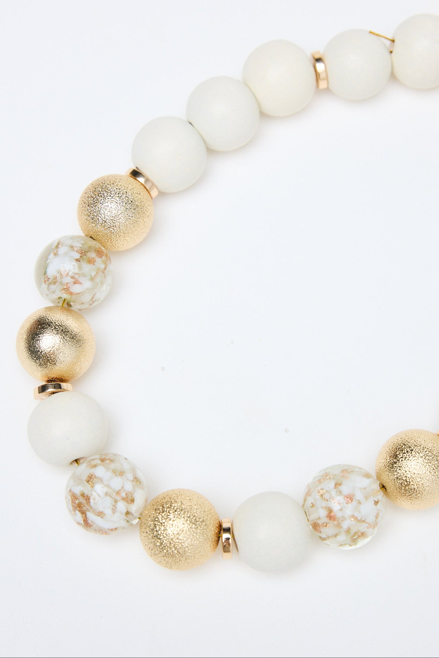 Necklace with white and gold beads on a white background
