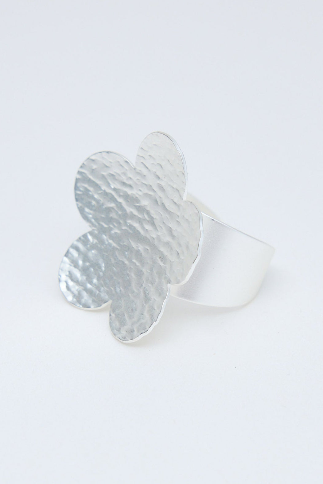 Silver flower-shaped ring on a white background