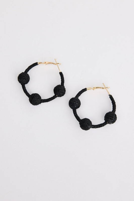 Black hoop earrings with spherical ends on a white background