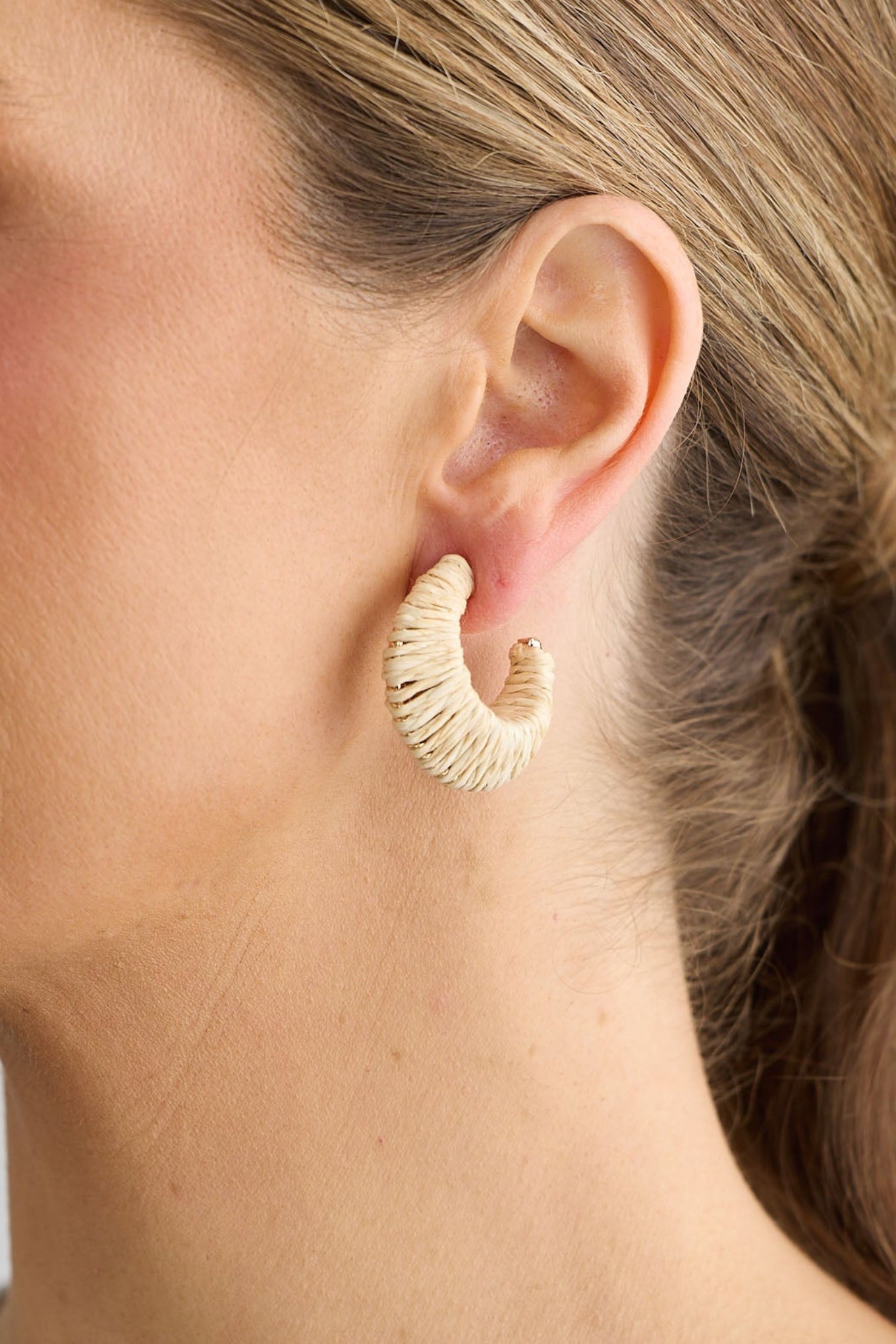 Close-up of natural nala earrings earrings on white background.