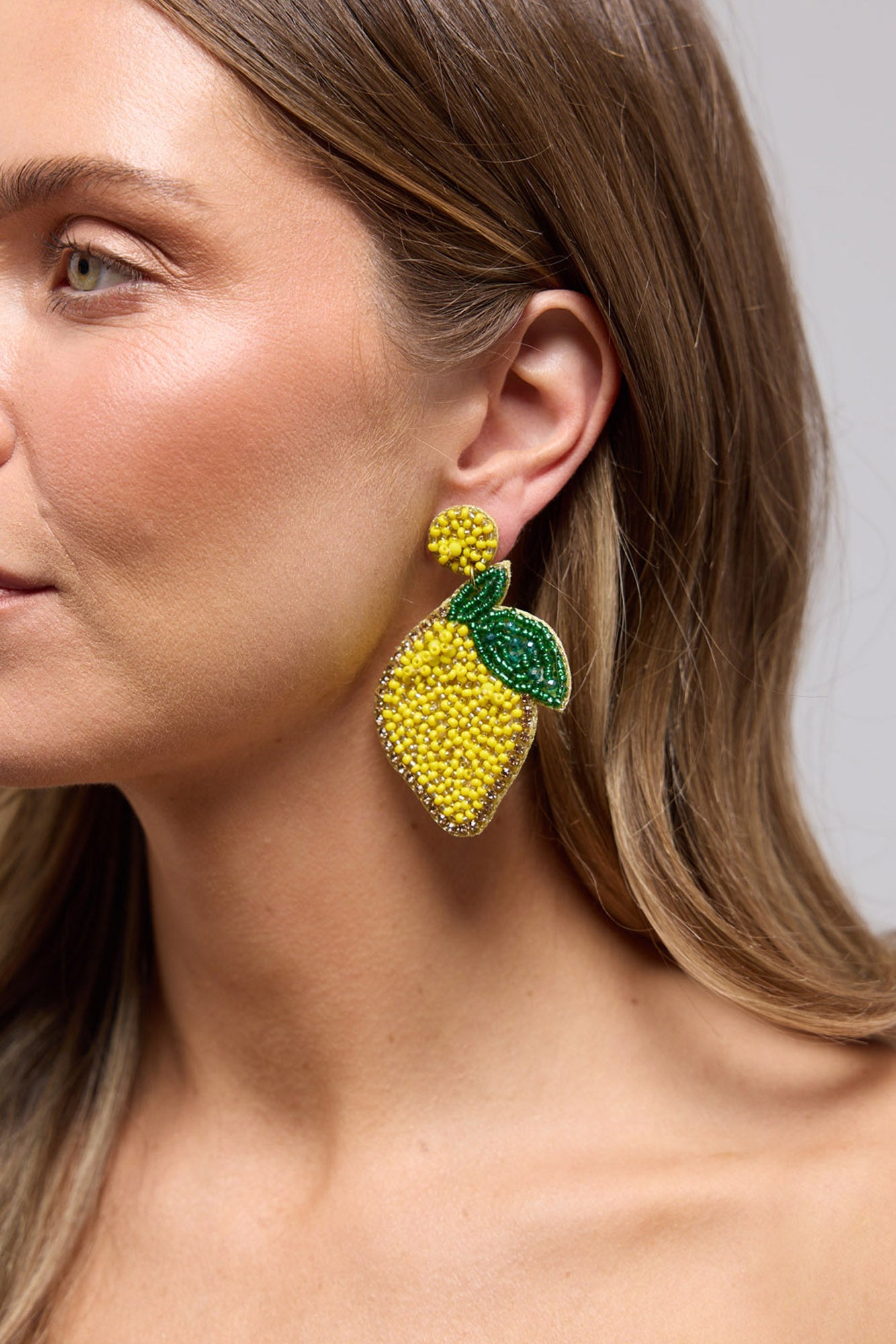 Lemon Earrings in yellow, front view.
