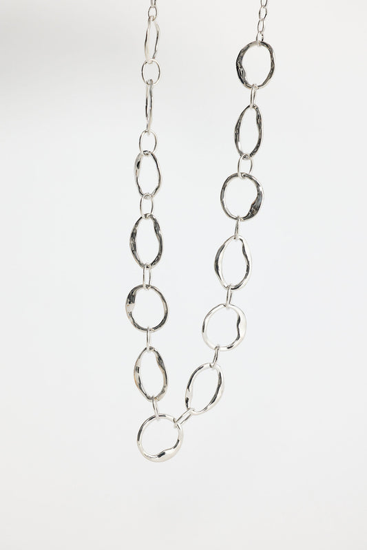 Close-up of silver hemsworth necklace necklace on white background.