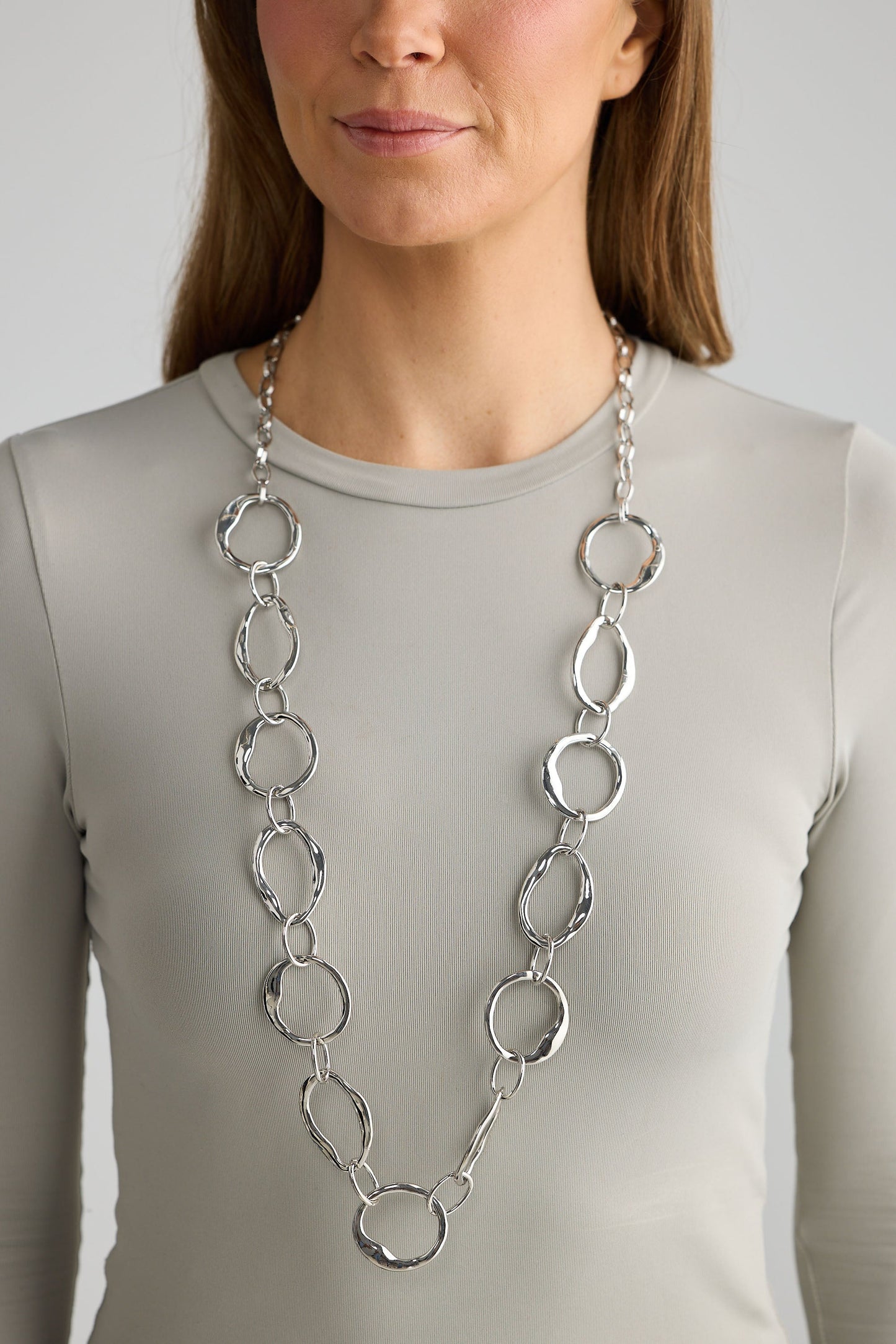 Close-up of silver hemsworth necklace necklace on white background.
